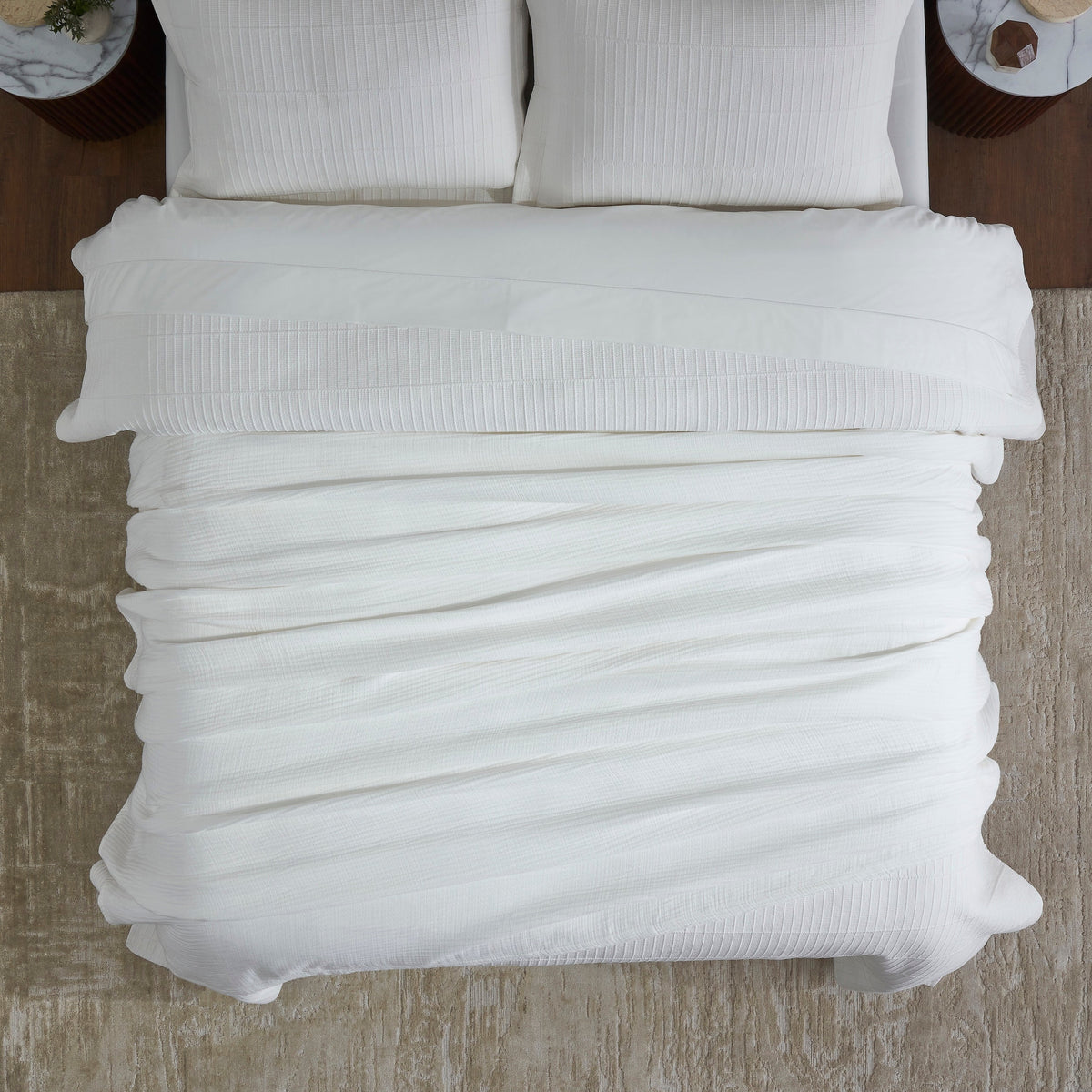 BL-861-9496_4|Overhead view of a neatly folded white textured cotton blanket on a bed, providing cozy comfort and a clean, modern aesthetic.