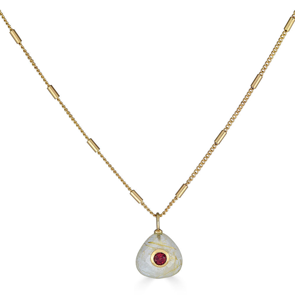 Gold chain necklace with a teardrop-shaped rutilated quartz pendant featuring a deep red garnet inlay