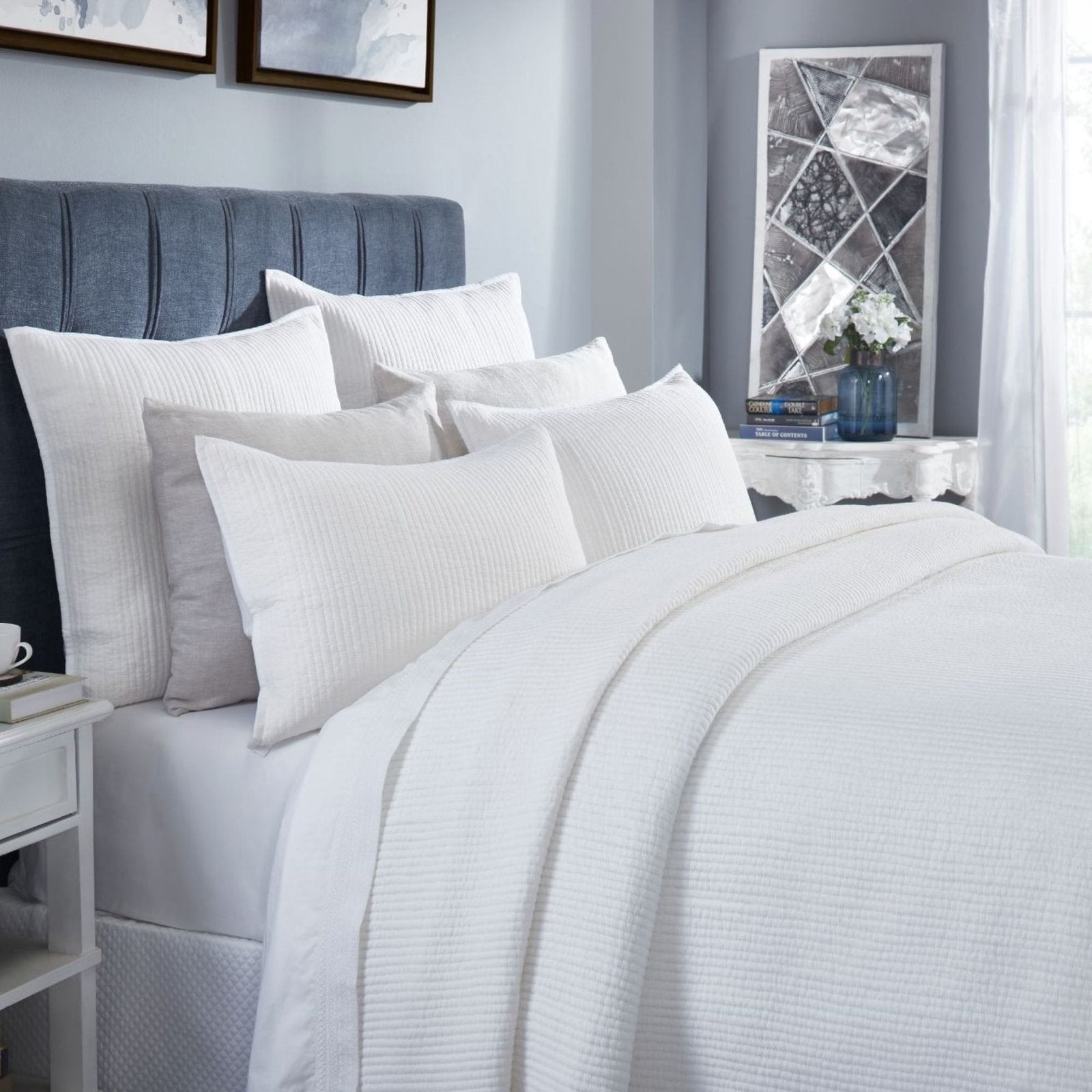 CL-196-11096_6|Close-up of a luxurious white channel stitch quilted coverlet, showcasing its soft texture and modern bedroom appeal.