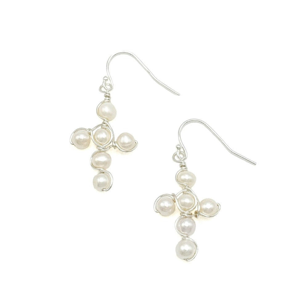 Pearl cross silver earrings modeled