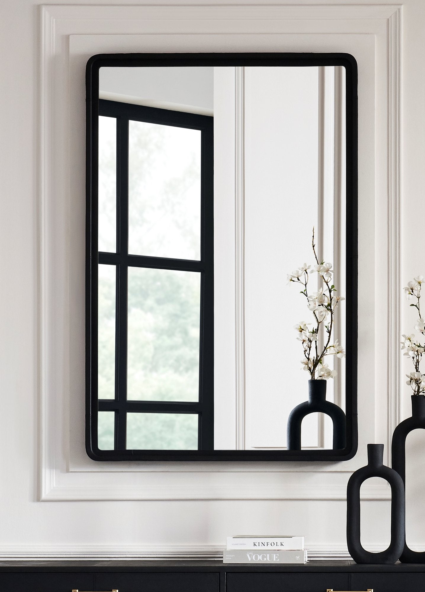 FN-5201-X_1|Sleek rectangular wall mirror with a modern black frame, reflecting light and enhancing the room's depth.