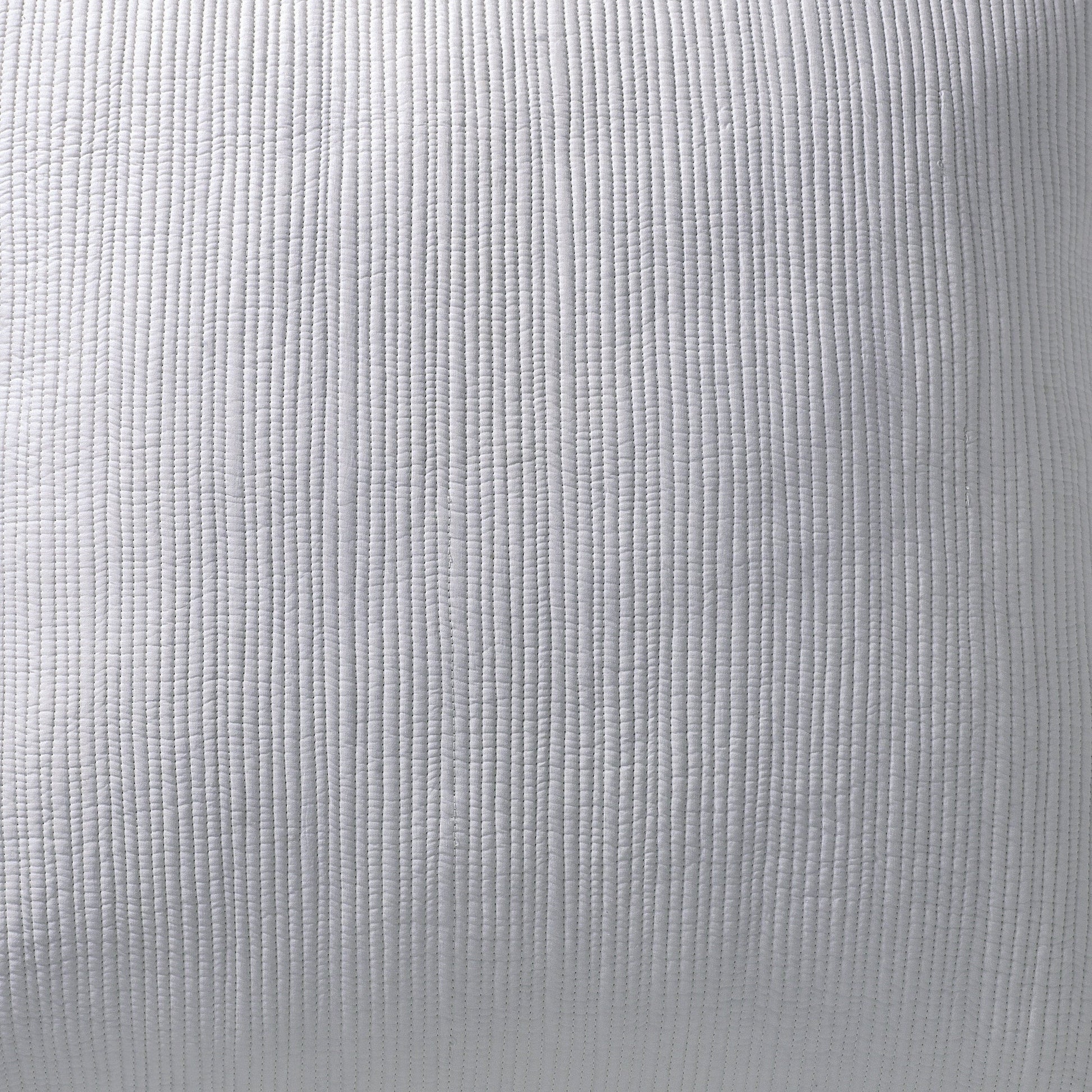 KS-168-2036-PO1269_LOT1_4|Light gray Coverlet fabric with fine, dense vertical channel quilting. Features a textured, ribbed surface with precise stitching.