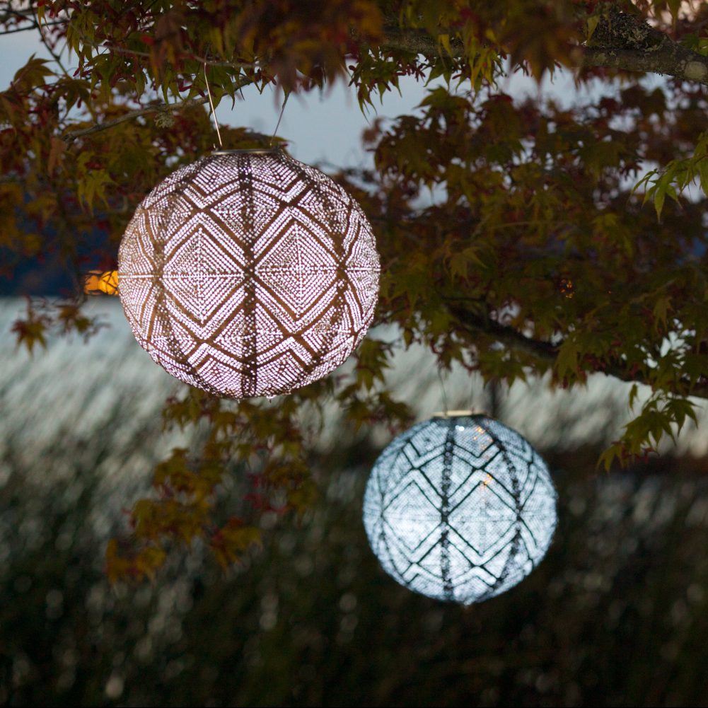 Soji Stella Market 12" Tyvek Solar Lantern hanging in tree