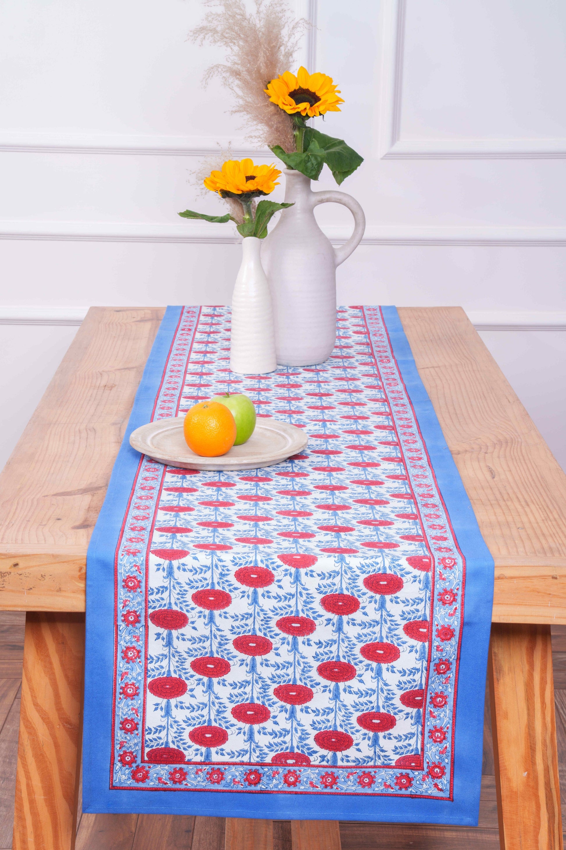 Inner Child Araminta Blockprint tablerunner with blue/red floral design, wooden table with fruit plate