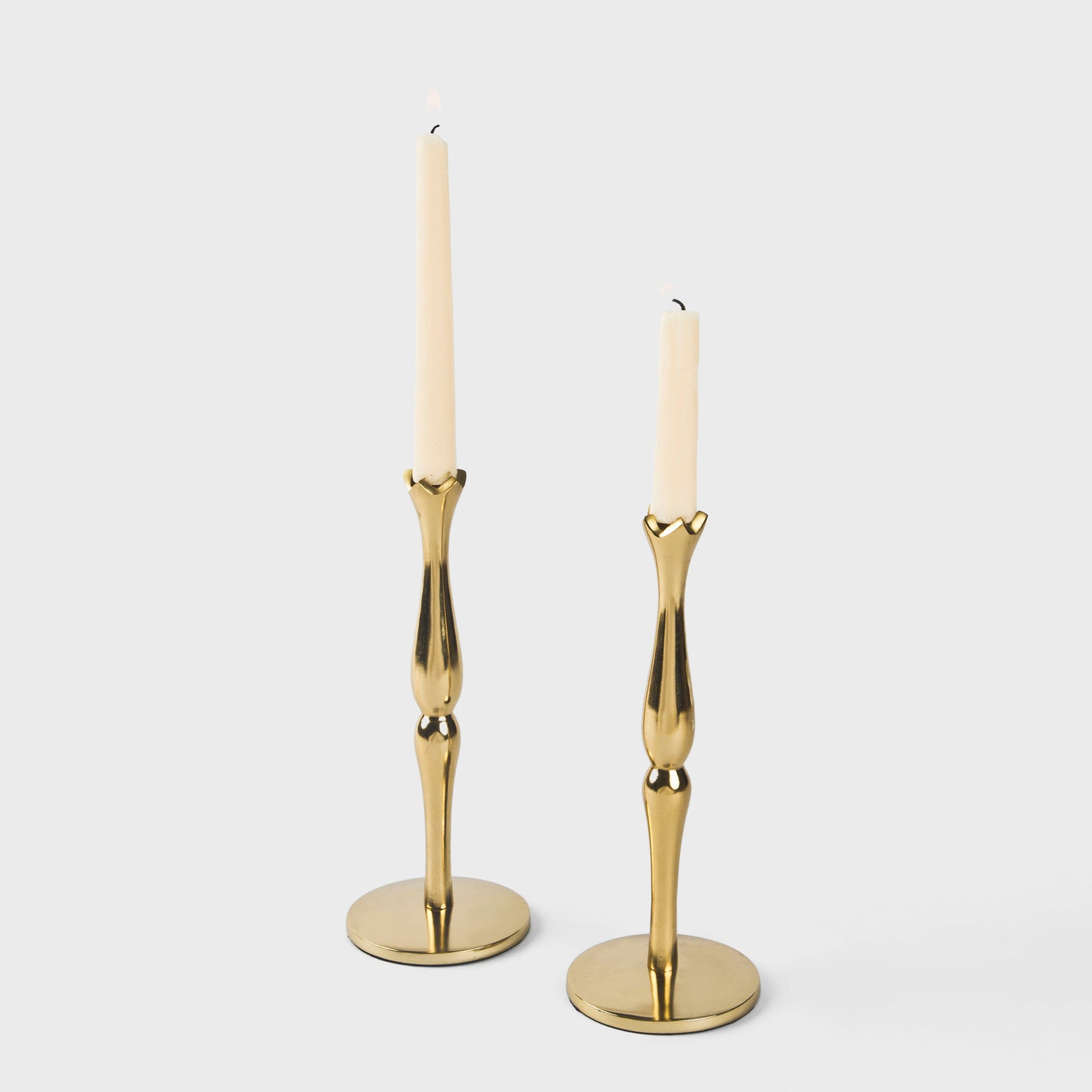 Traditional 9-inch tall gold metal candle holders with a weighted base and smooth finish