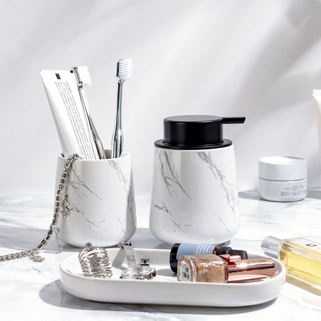 BosilunLife Marble 3-piece recycled eco-clay bathroom set styled on a bathroom vanity countertop holding toothbrushes, cosmetics, and jewelry.