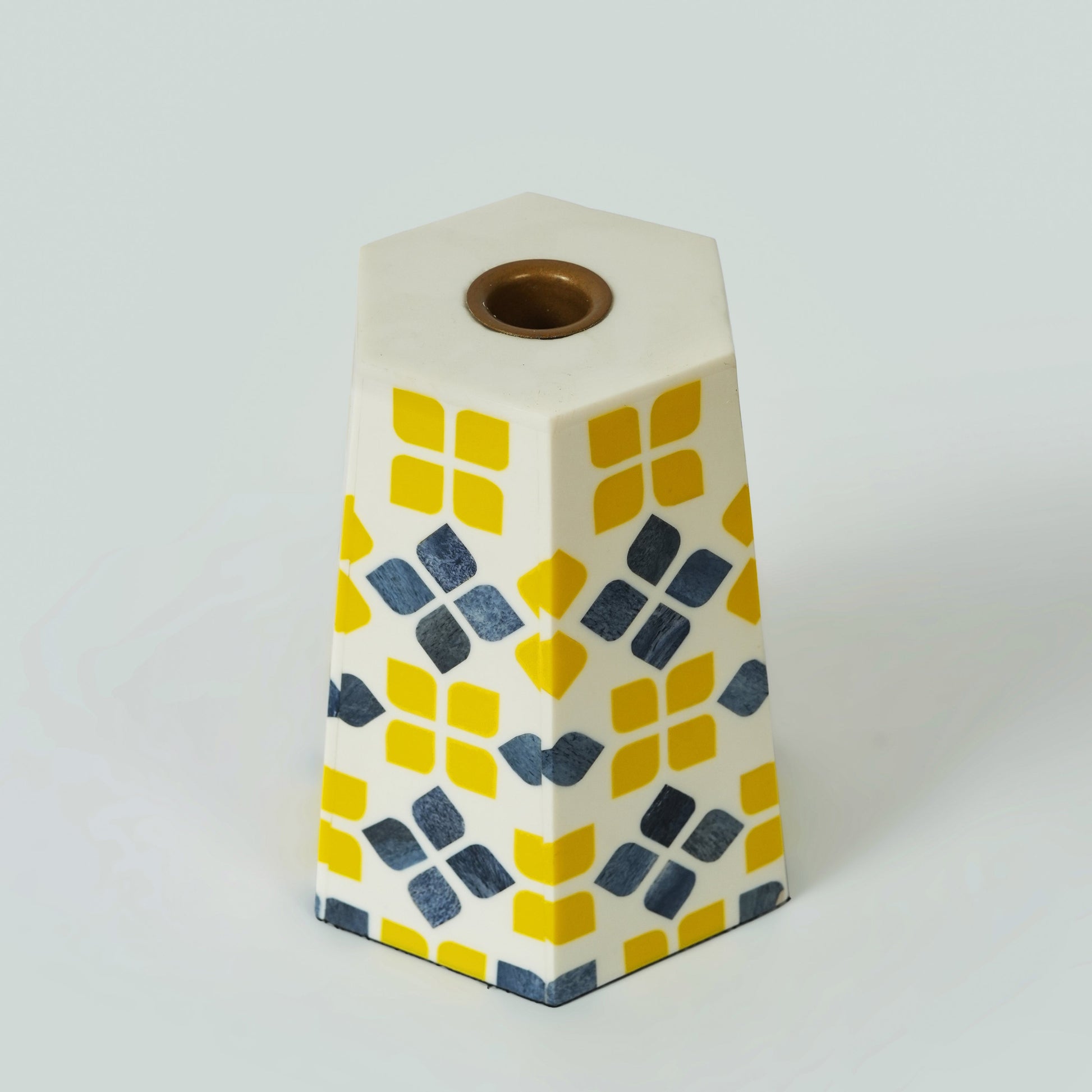 Side view of the hexagonal bone inlay candle holder showing the geometric floral pattern and natural wood base.
