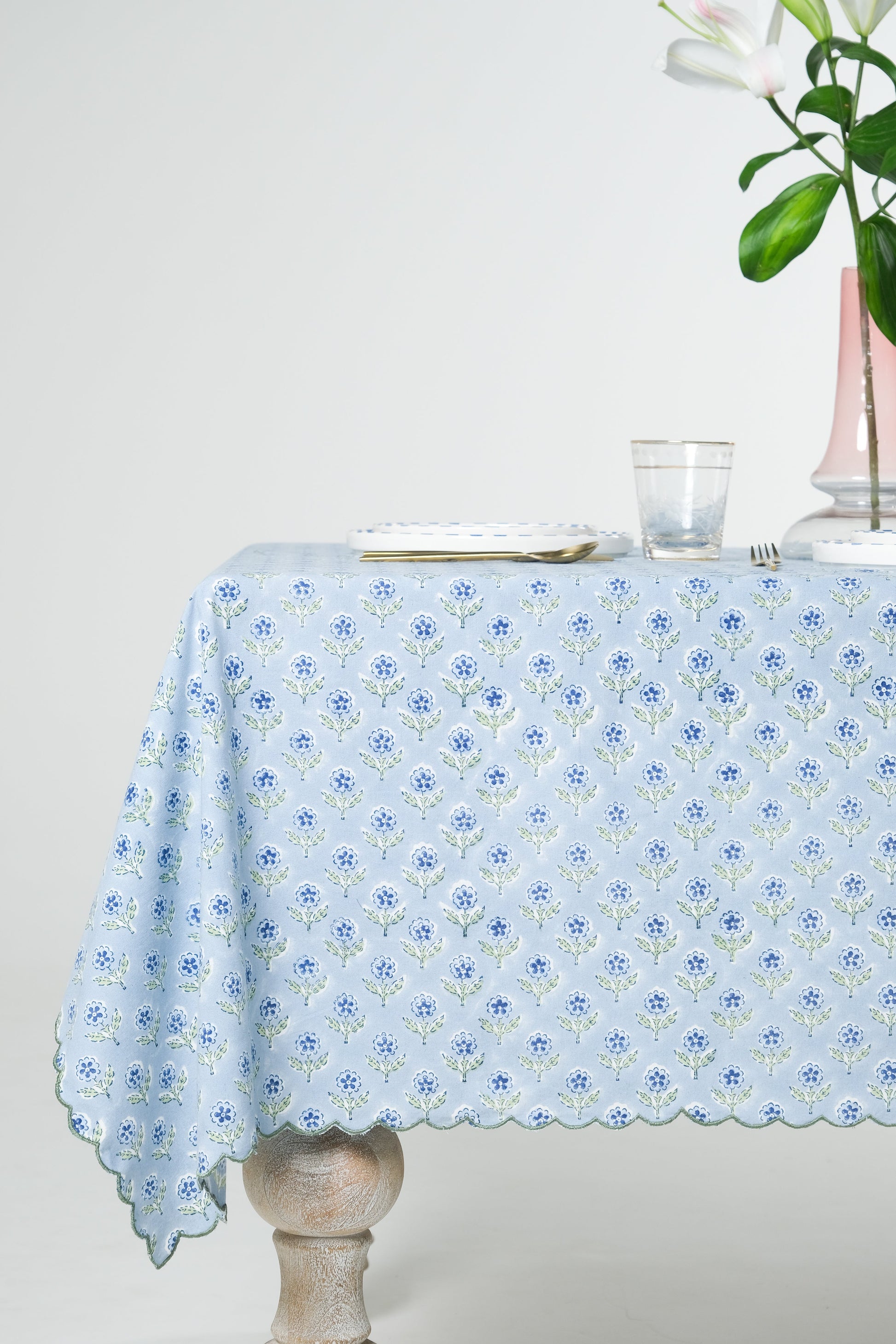 Inner Child blue scallop-edged embroidered blockprint tablecloth on wooden table