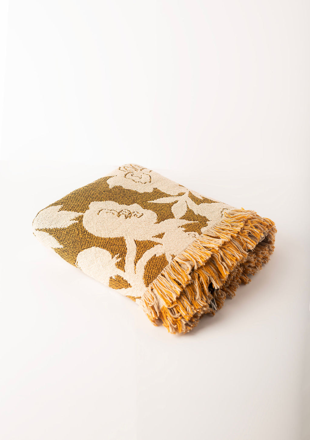 Folded Addy Ochre gold floral reversible jacquard woven throw blanket