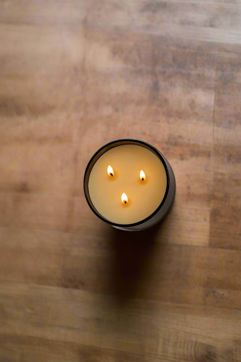 overhead view of natural 3-wick candle burning