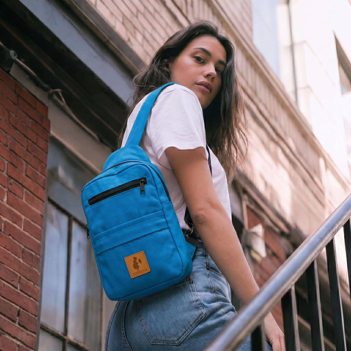 Umoja canvas sling bag in Zilly Blue worn crossbody #color_zilly-blue