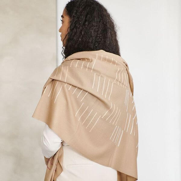 Model showcasing the Maple Beige Handwoven Hand Embroidered Classic Scarf draped over shoulders.