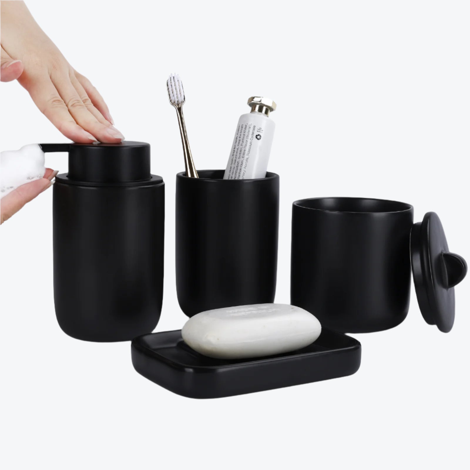 Black bathroom accessory set with toothbrush, soap, and other items on a white background
