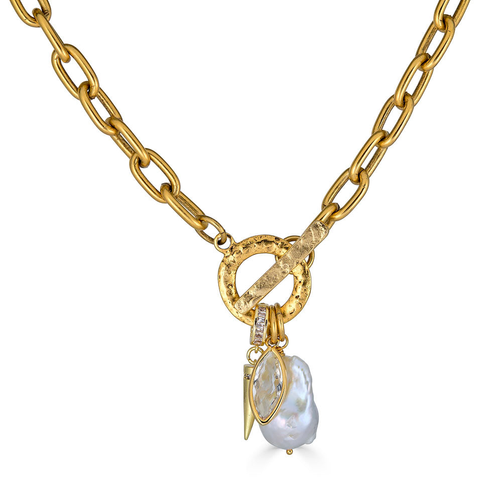 Gold chain necklace with toggle clasp, featuring a baroque pearl, marquise-cut crystal, and gold spike charm