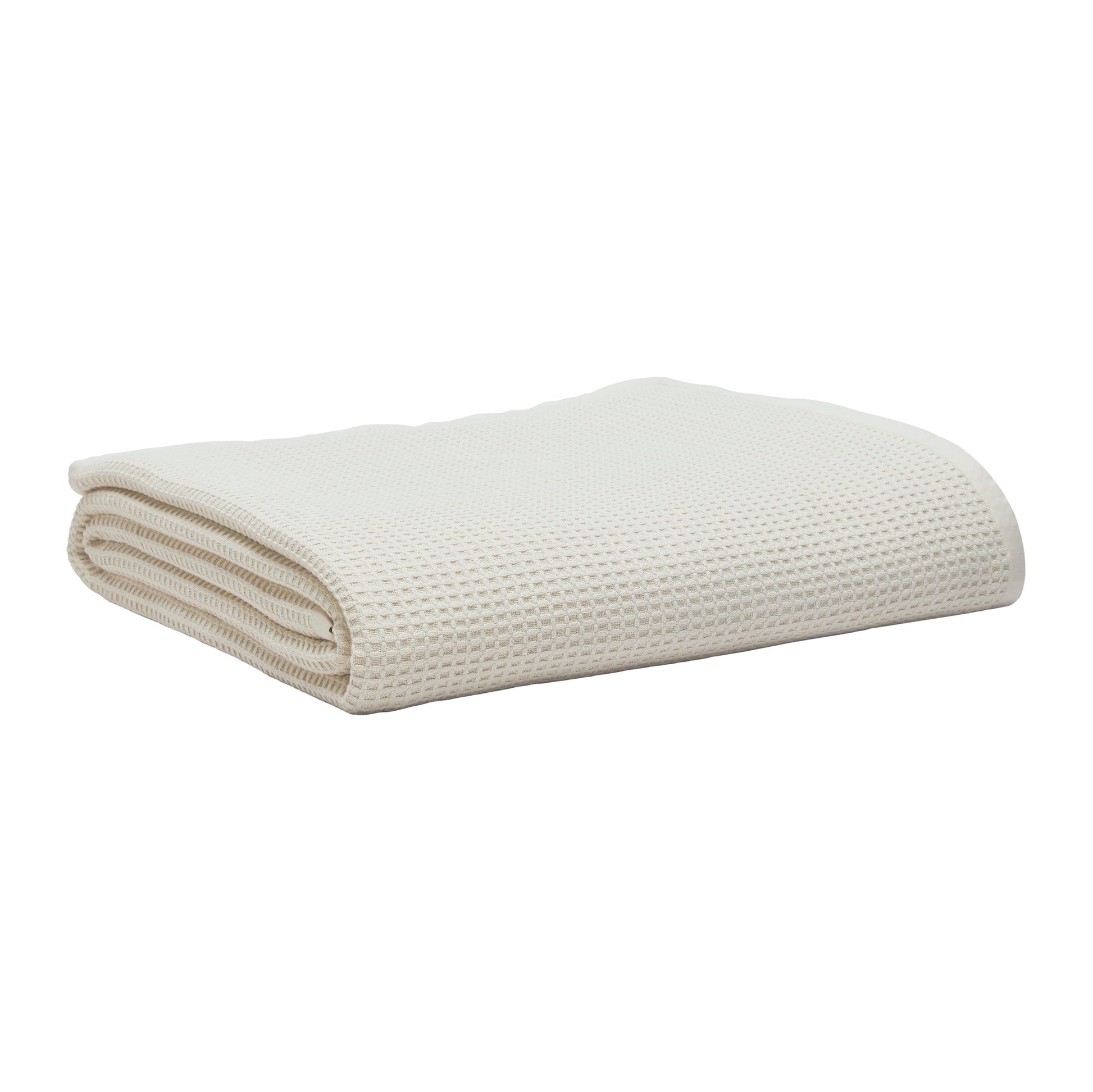 BL-867-9496_3|Folded cream waffle weave blanket. Soft, breathable cotton throw blanket for bed or sofa, adding texture and warmth to any room.