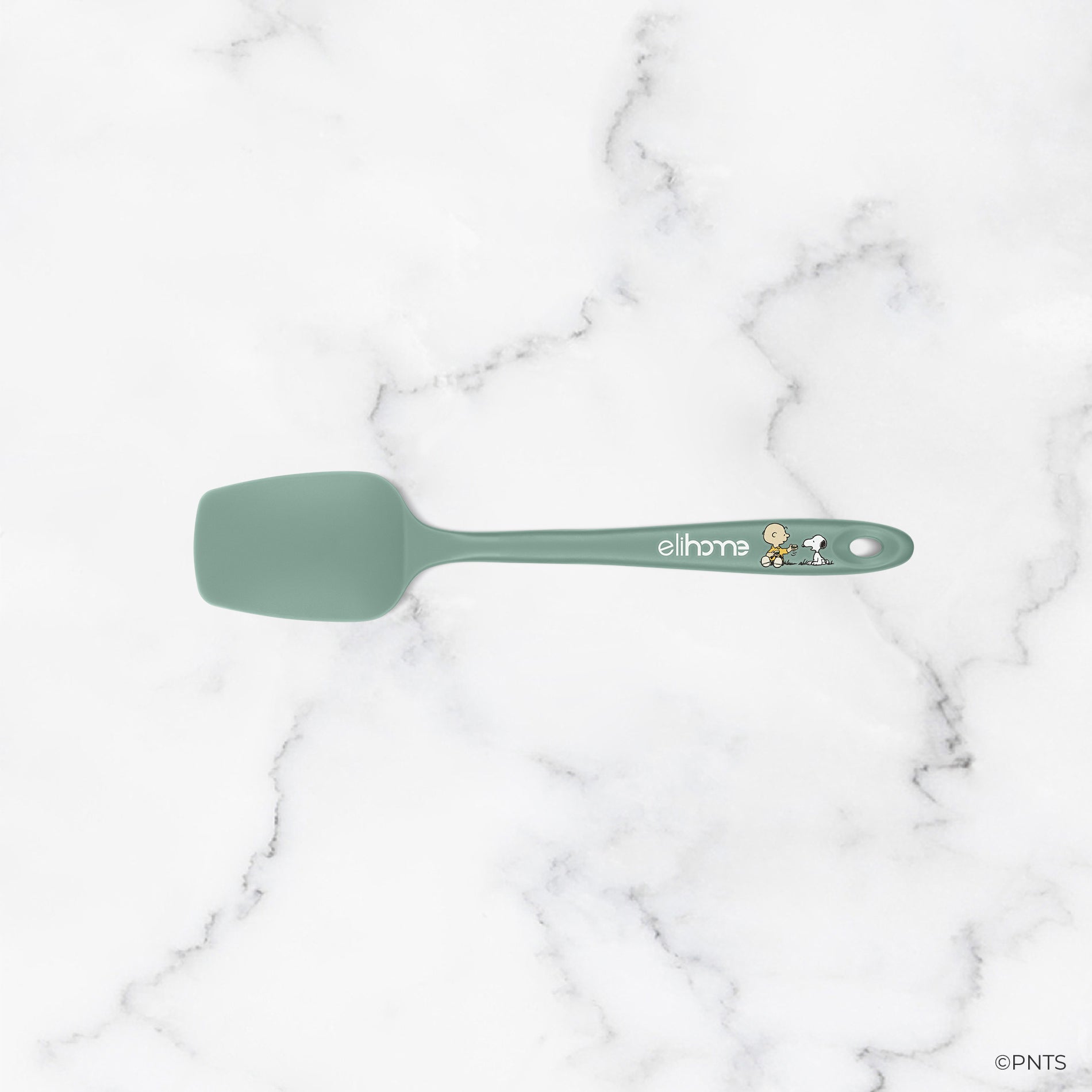 Green spatula on a marble background
