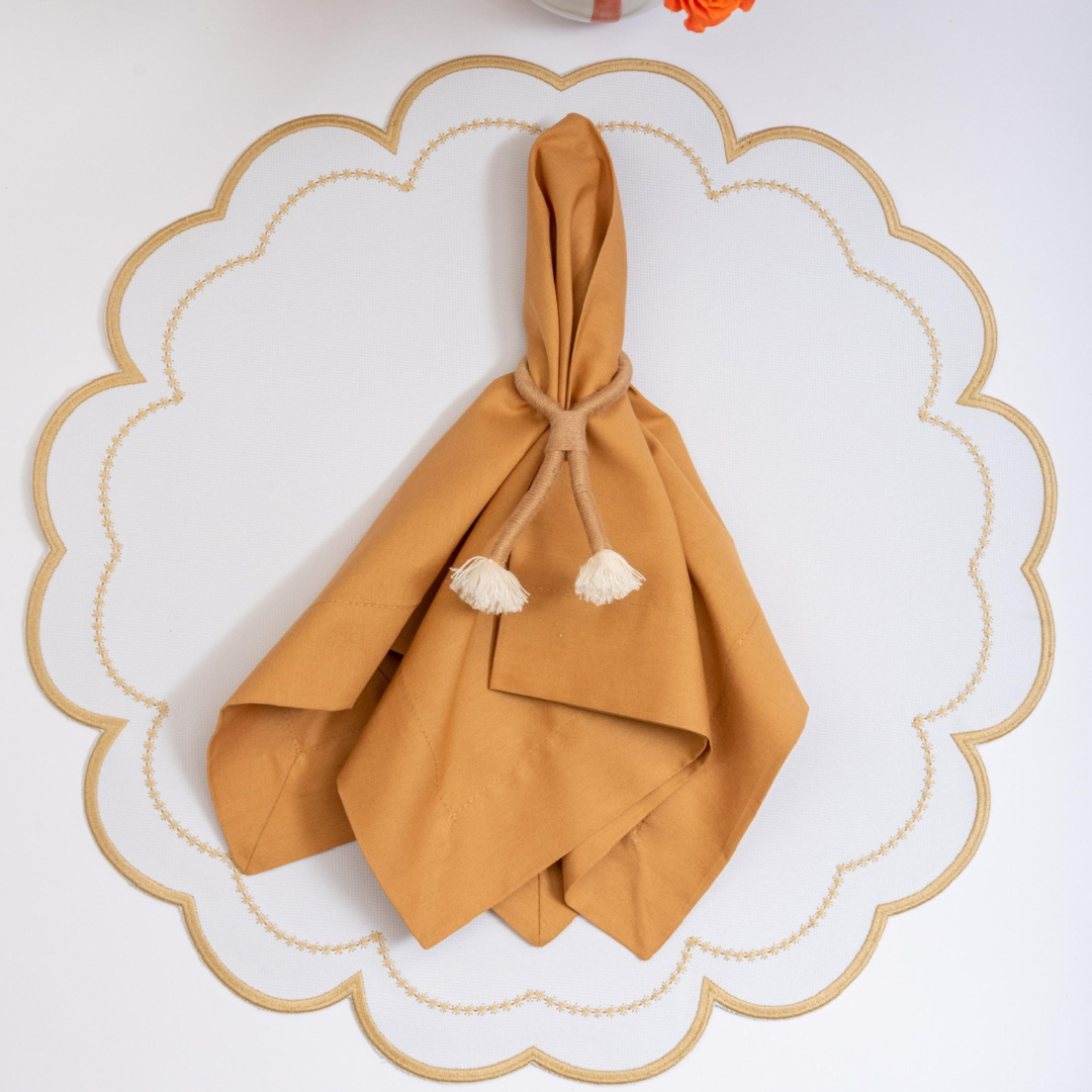 The sand Victoria impermeable placemat with Victorian-style border detail by Talah Home