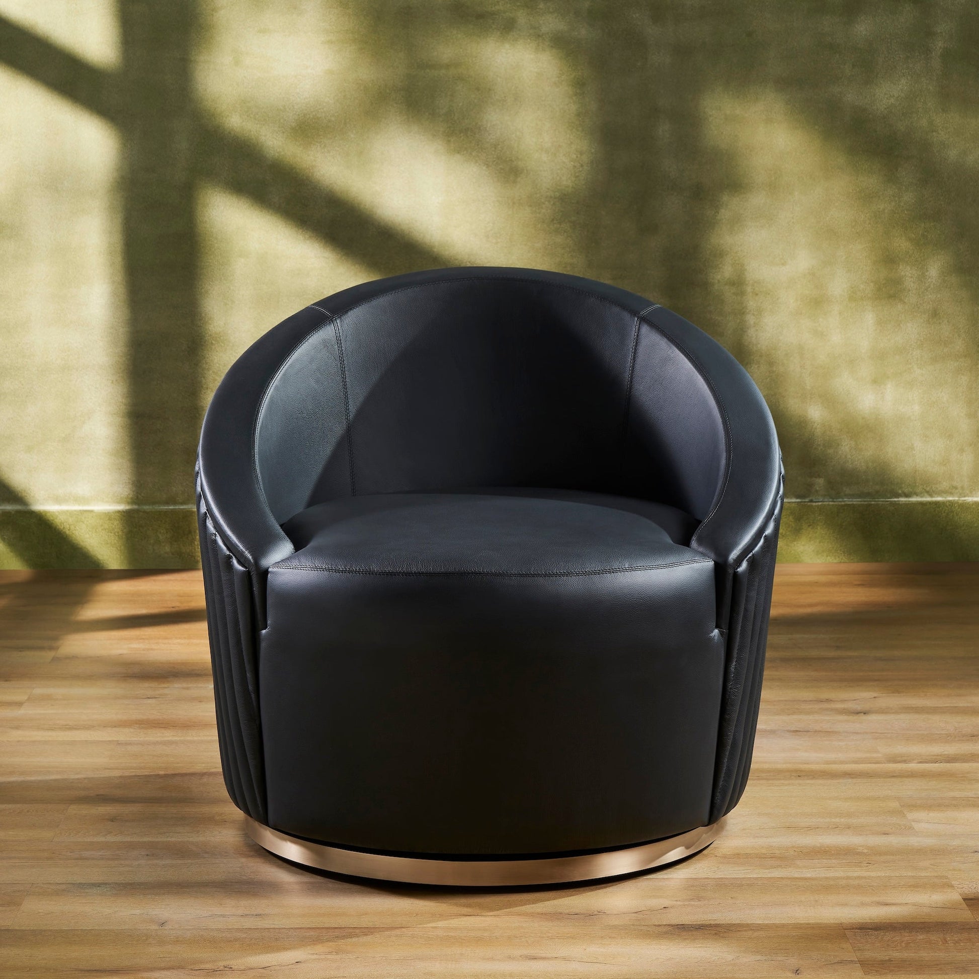 FN-5207-353529_2|Luxurious black leather swivel chair with sleek, comfortable design and a shimmering gold metal round base, perfect for modern spaces.