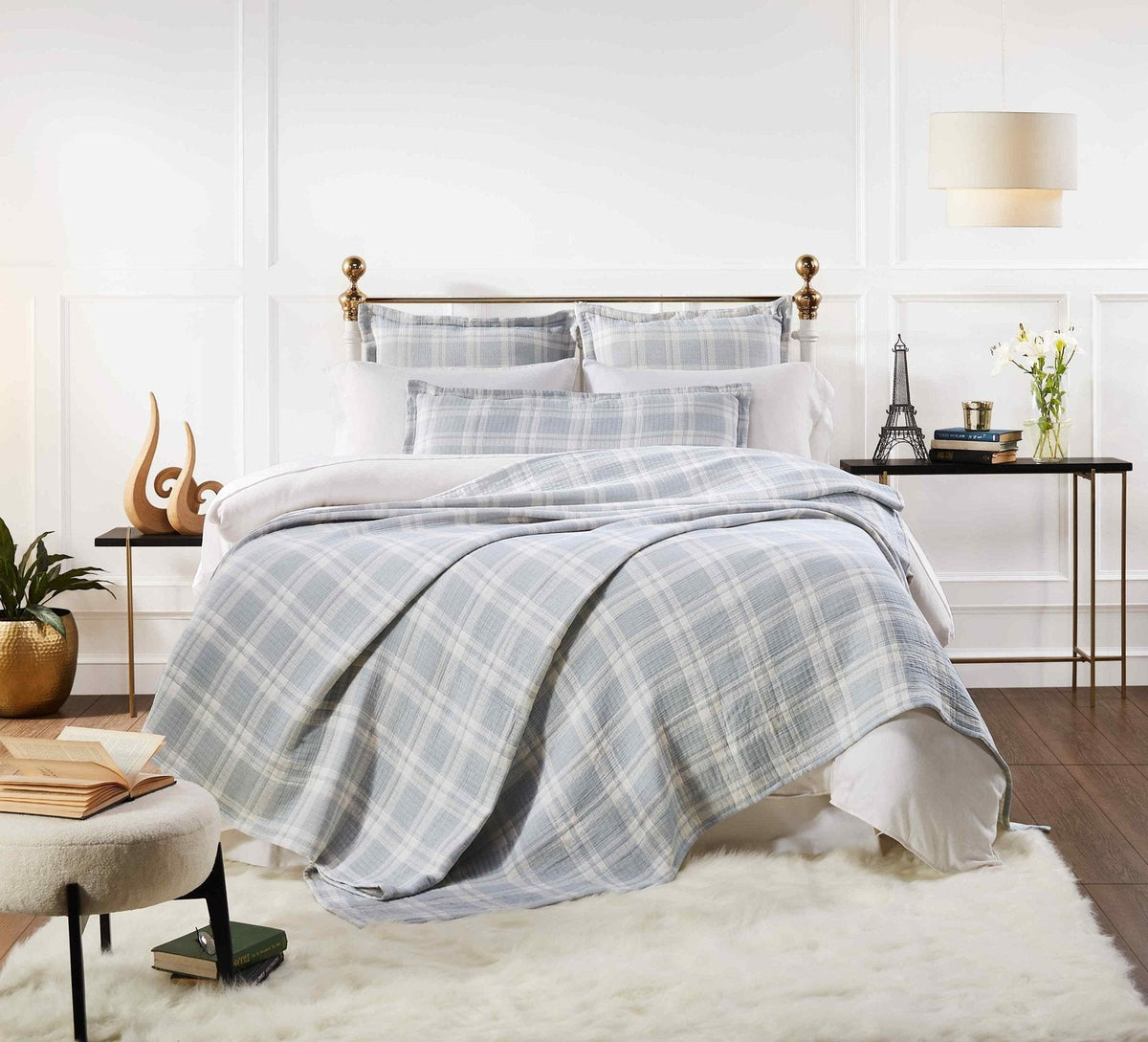 BT-117-9496_1|Light blue and white plaid patterned cotton quilt blanket draped over a bed, creating a cozy and stylish bedroom aesthetic.