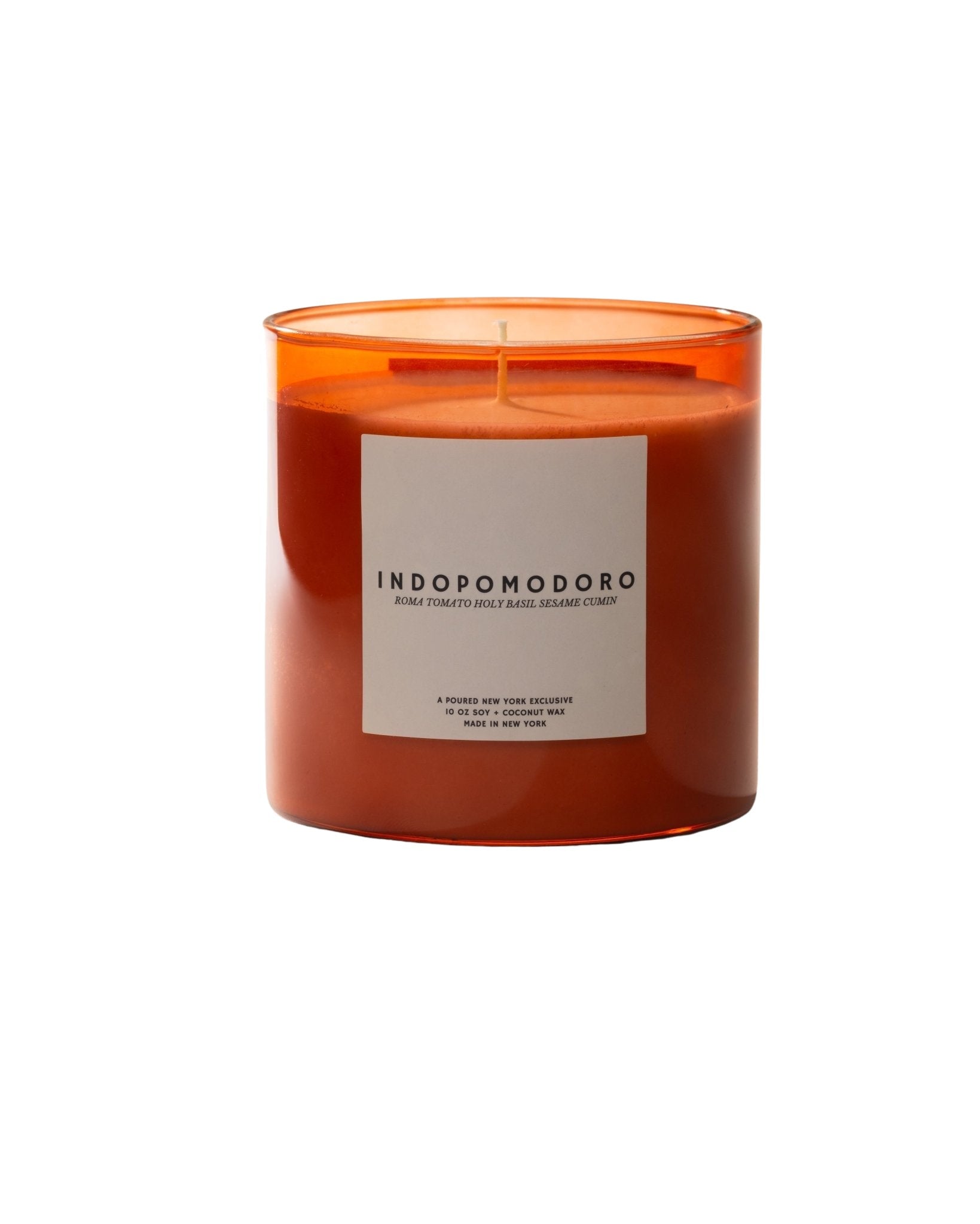 Poured New York 'Indopomodoro' tomato red glass candle with a matching red candle box with tomato vine decal on neutral background