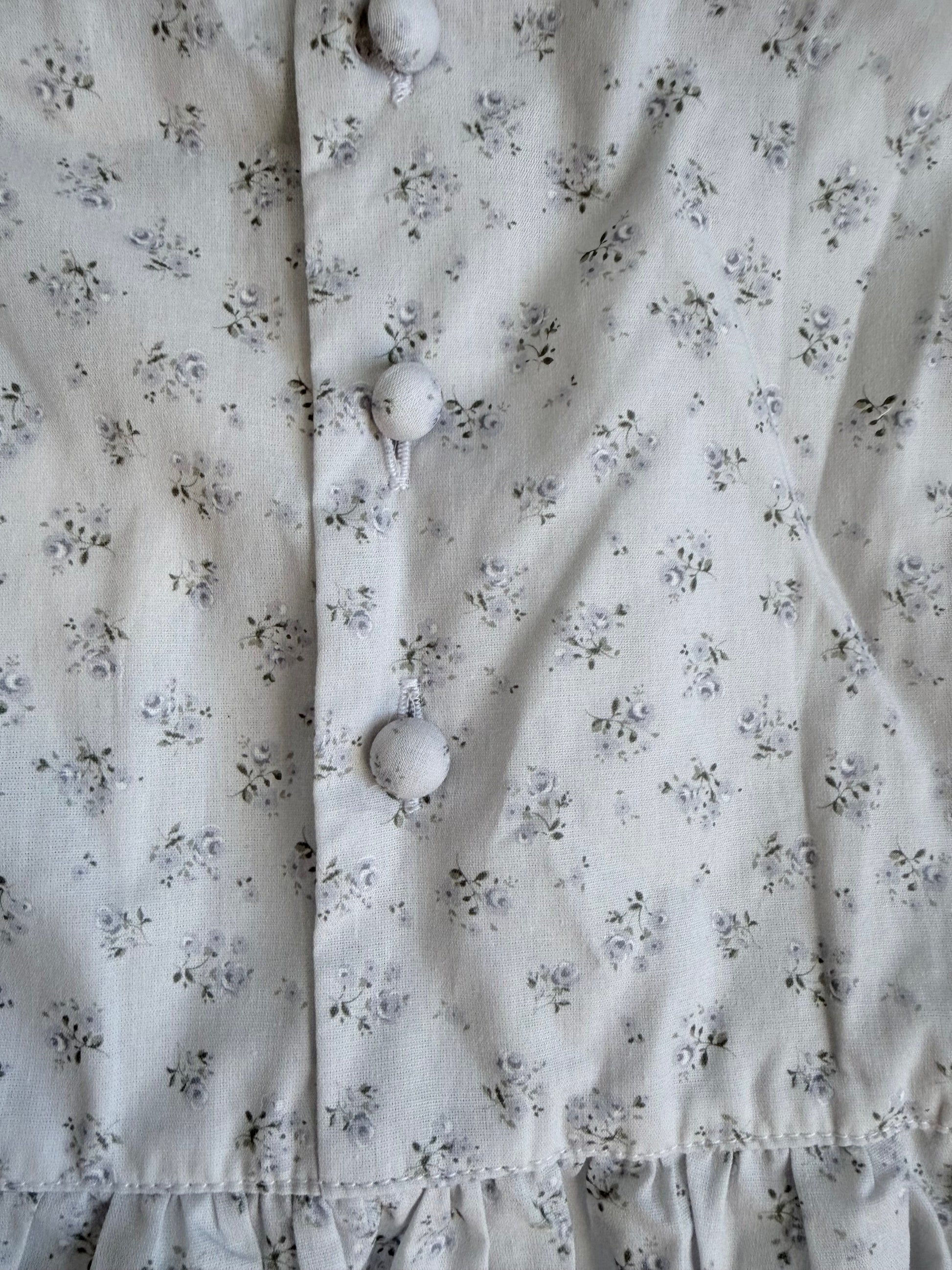 Floral patterned fabric with buttons on a light background