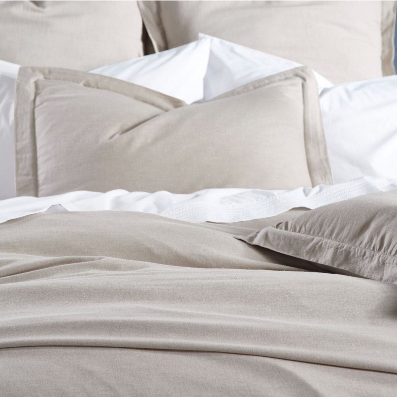 DT-036-9092_4|Close-up of a cozy, plain beige duvet cover and matching pillow shams, providing a comfortable and inviting bed.