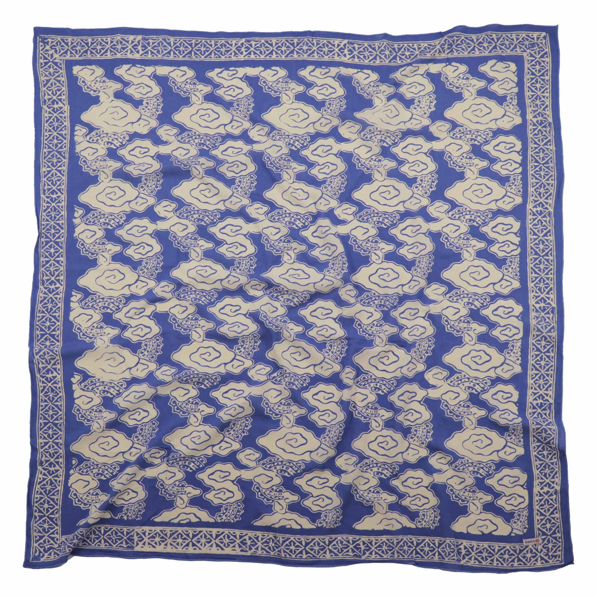 Blue and white patterned bandana square on a white background