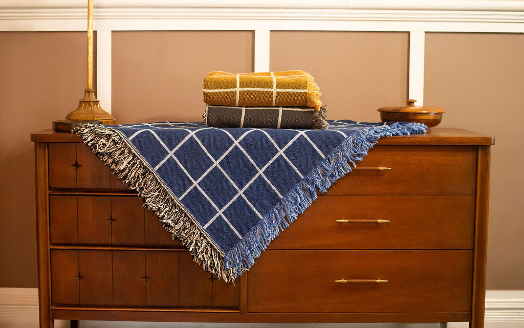 Folded Greer Lapis blue grid reversible jacquard woven throw blanket