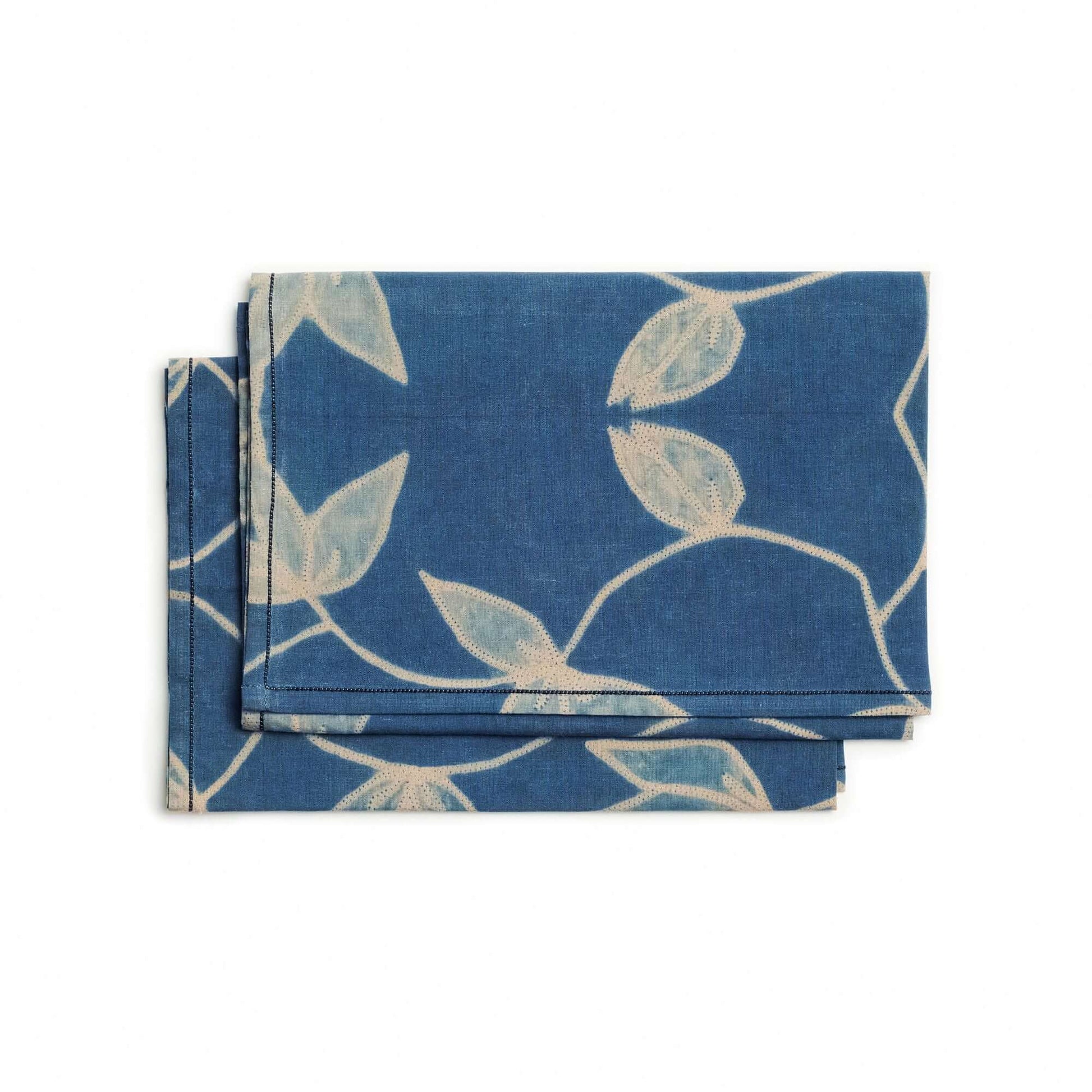 Folio Indigo Handcrafted Shibori Cotton Table Napkins ( set of 4 ) displayed in vibrant blue with elegant leaf patterns.