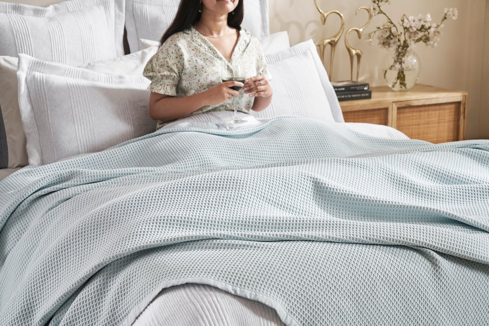 BL-857-9496_5|Woman relaxing in bed, covered by a light blue waffle knit blanket, for ultimate cozy comfort. (111)
