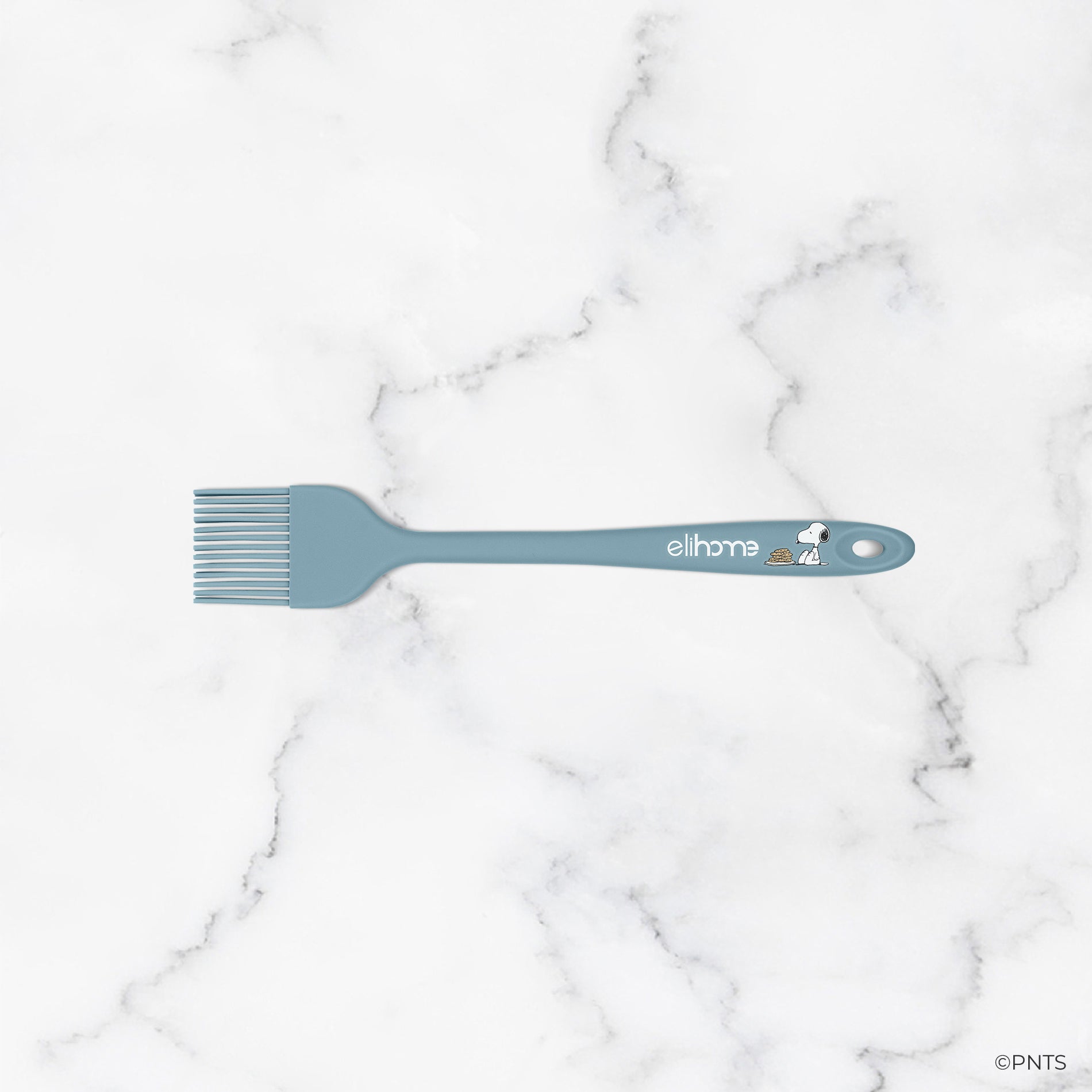 Green spatula with 'elihome' branding on a marble background