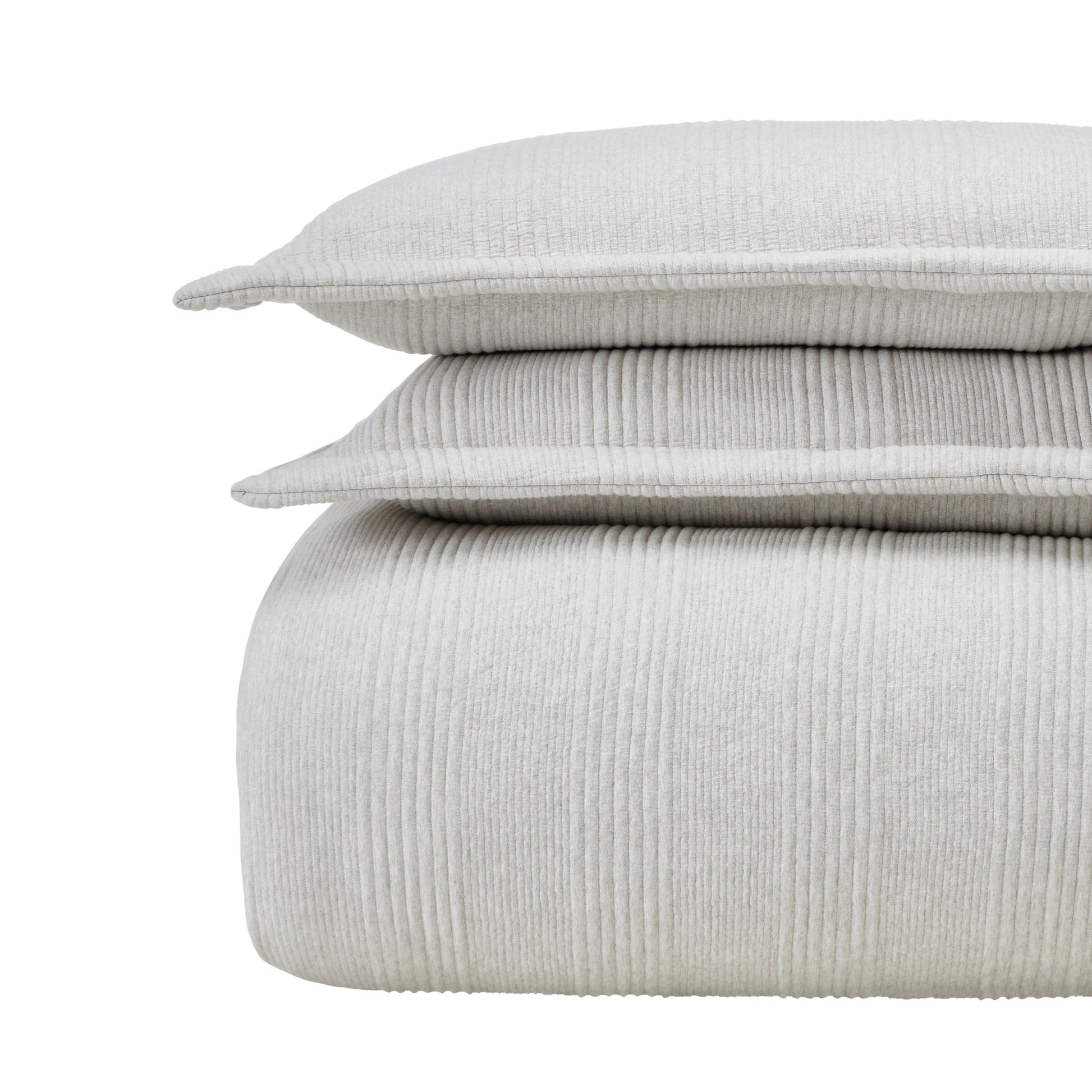 DT-044-9092_5|Stacked light grey ribbed duvet cover and two textured pillow shams, offering cozy comfort and modern style for any bedroom.