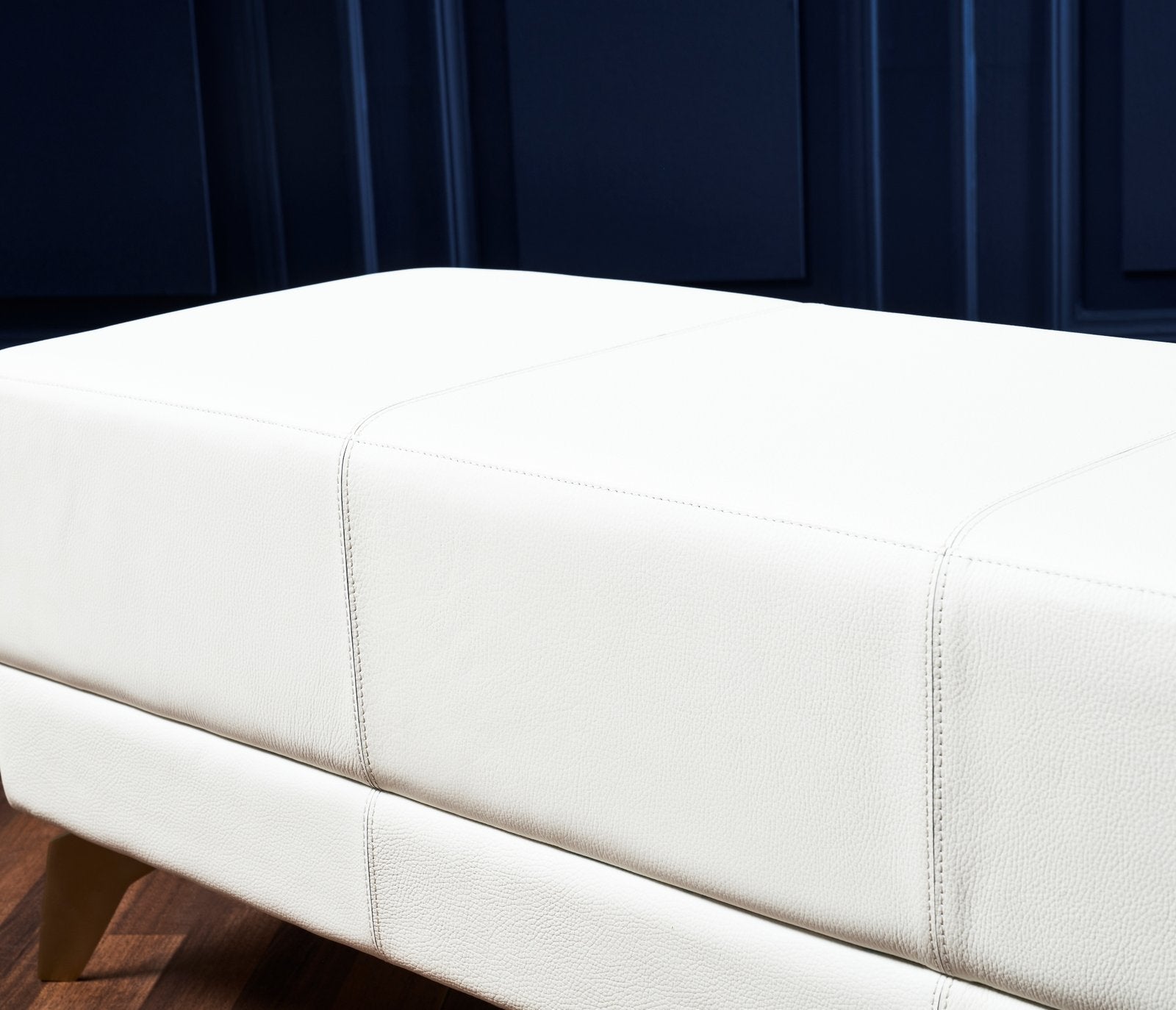 FN-5201-601618_4|White genuine leather ottoman detail. Upholstered furniture with fine stitching and natural texture for modern home decor.