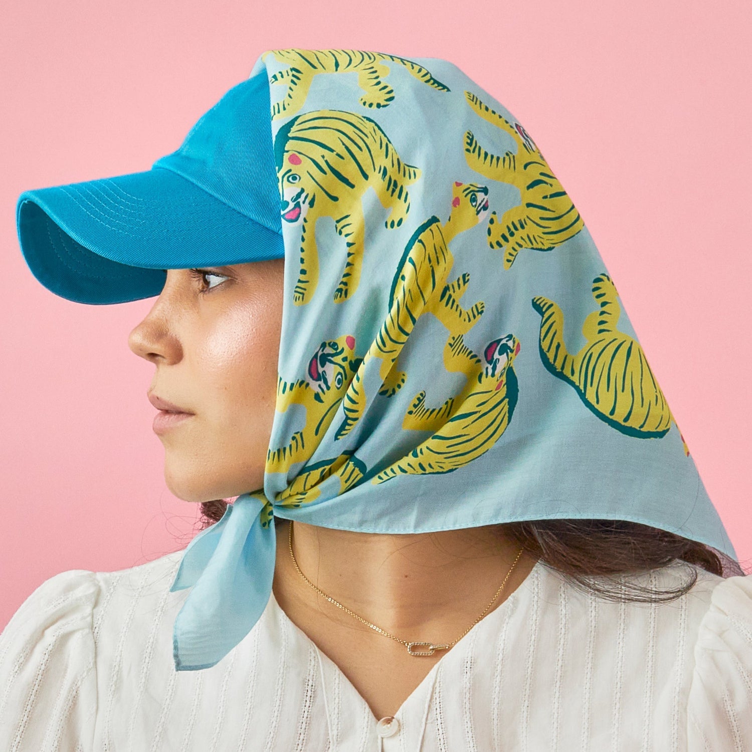Nodding tigers cotton silk bandana on blue , pink and neon yellow for a fun look. Made of a luxurious cotton-silk blend with a precise machine-stitched hemming, perfect as head wraps or neckerchiefs, bandana hairstyles, bandana headband; bandana style is in and now. Ethically sourced.