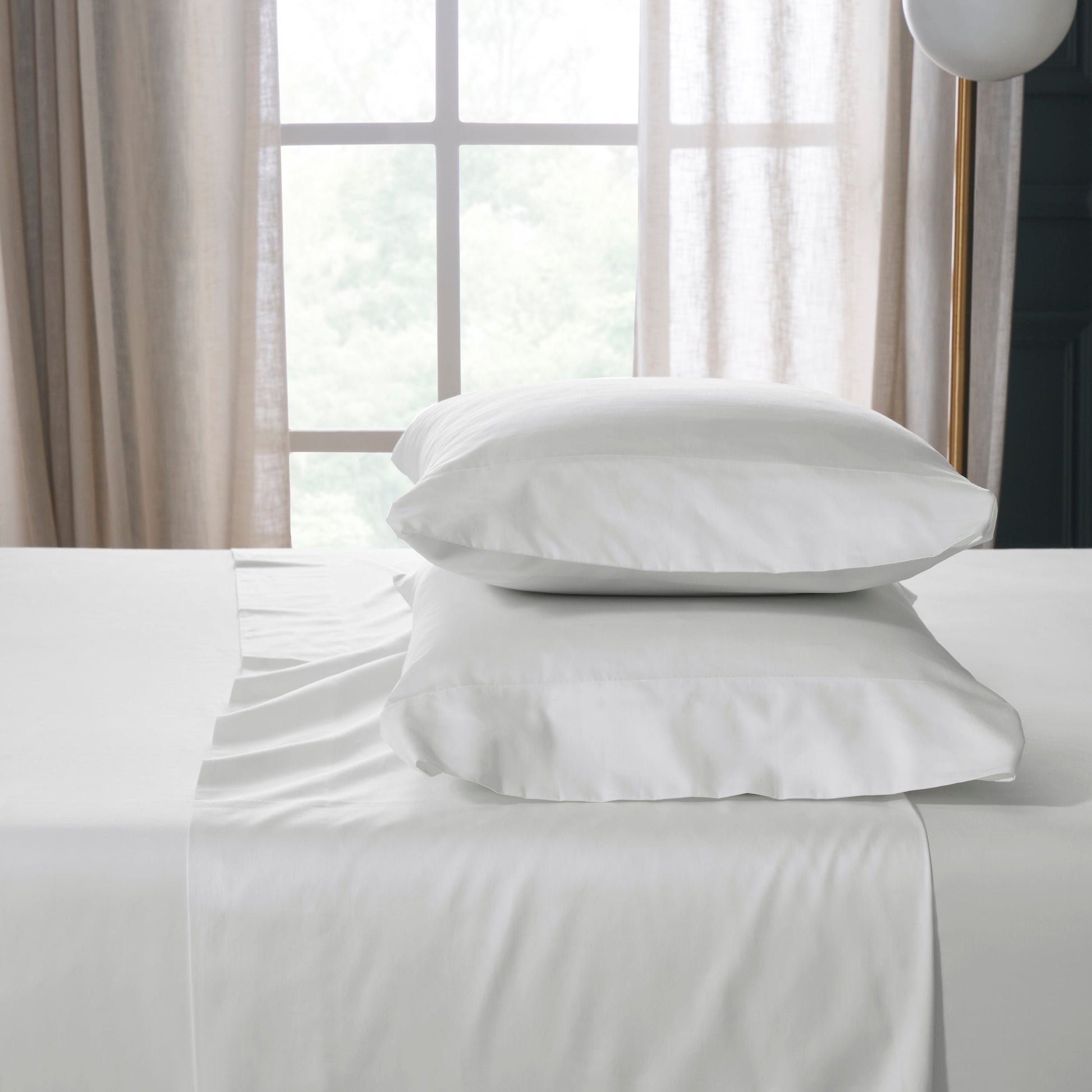 QSS-539-6080_2|Stack of pure white 100% cotton sheets and two soft pillowcases, highlighting premium, breathable bed linens.