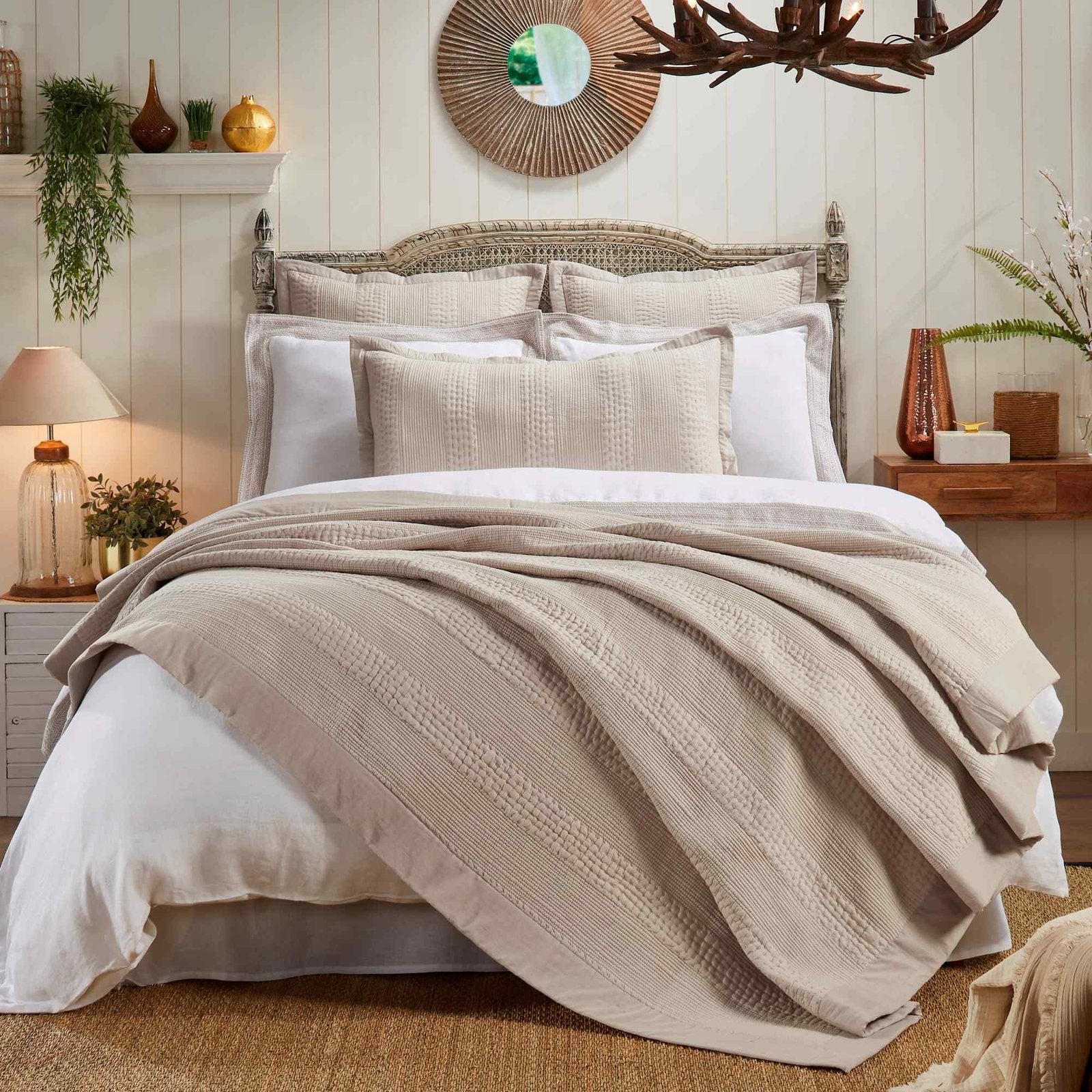 CL-164-11096-LOT1_1|Natural beige textured coverlet elegantly draped on a bed, creating a warm, inviting layer for a sophisticated bedroom setting.