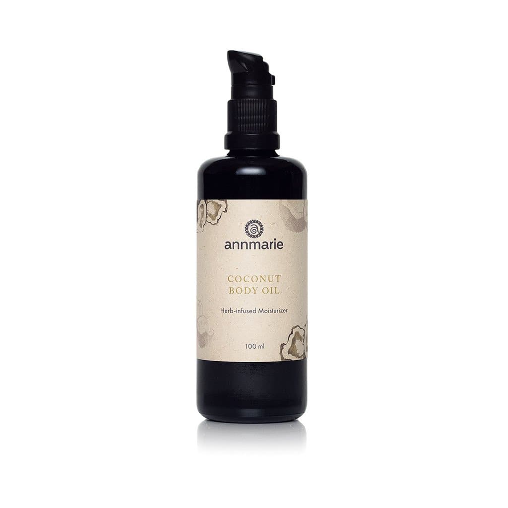 Coconut Body Oil herb-infused moisturizer in dark glass pump bottle for all skin types, 100 ml.