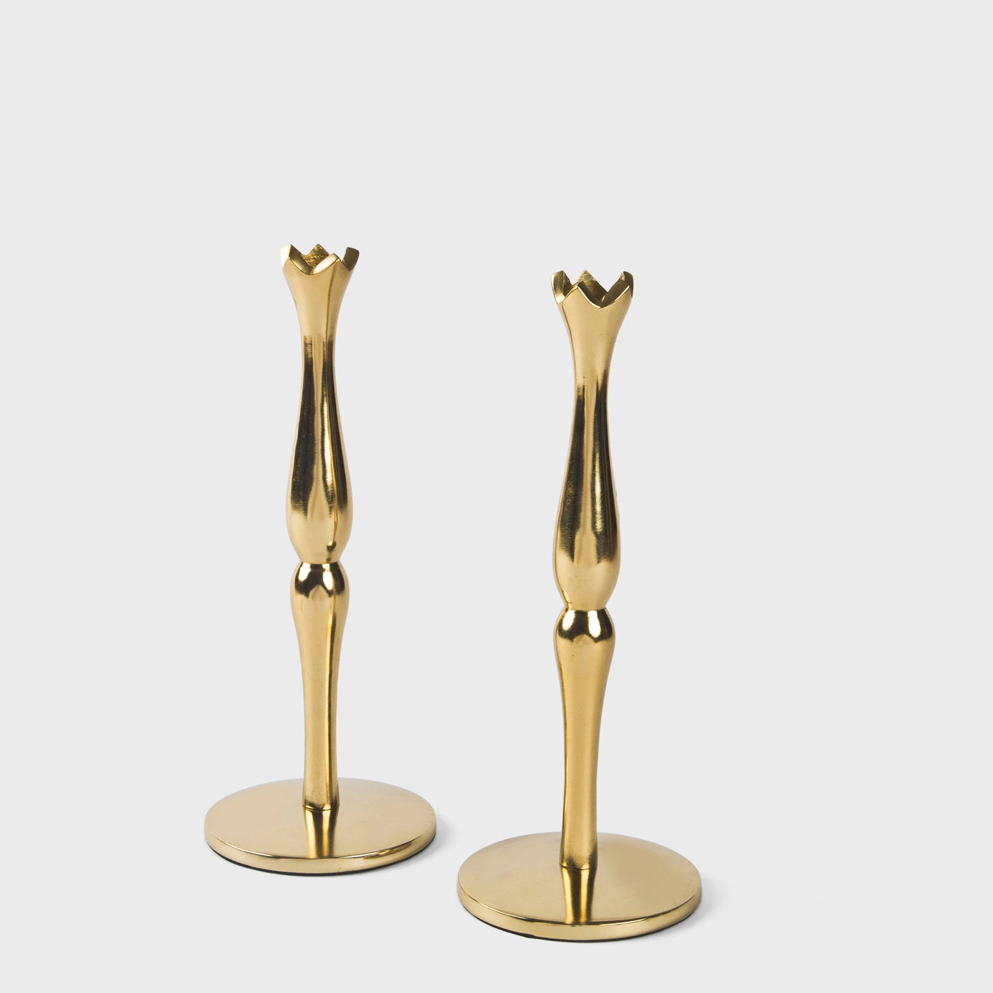 Handcrafted solid brass candlestick set for festive holiday dining and elegant mantle decor.