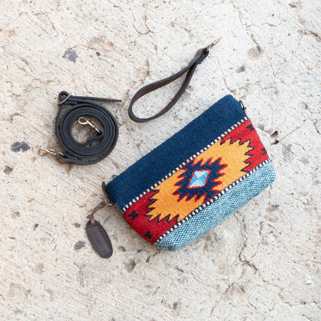 Handwoven convertible clutch with Zapotec pattern in bold colors; can be used as a pouch, wristlet, or crossbody with included leather straps and internal pocket.