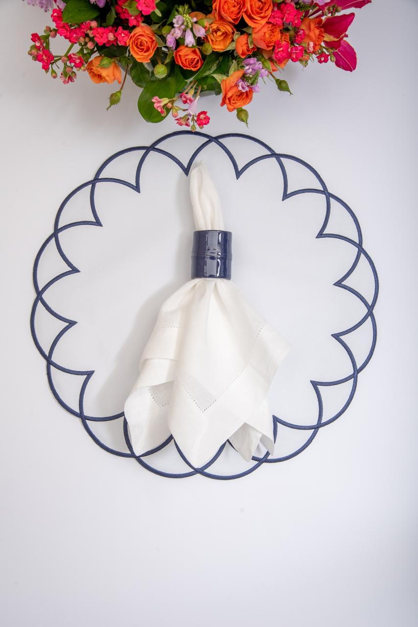 Arc impermeable placemat with embroidered border in white with navy stitching by Talah Home — spill-proof Brazilian table decor