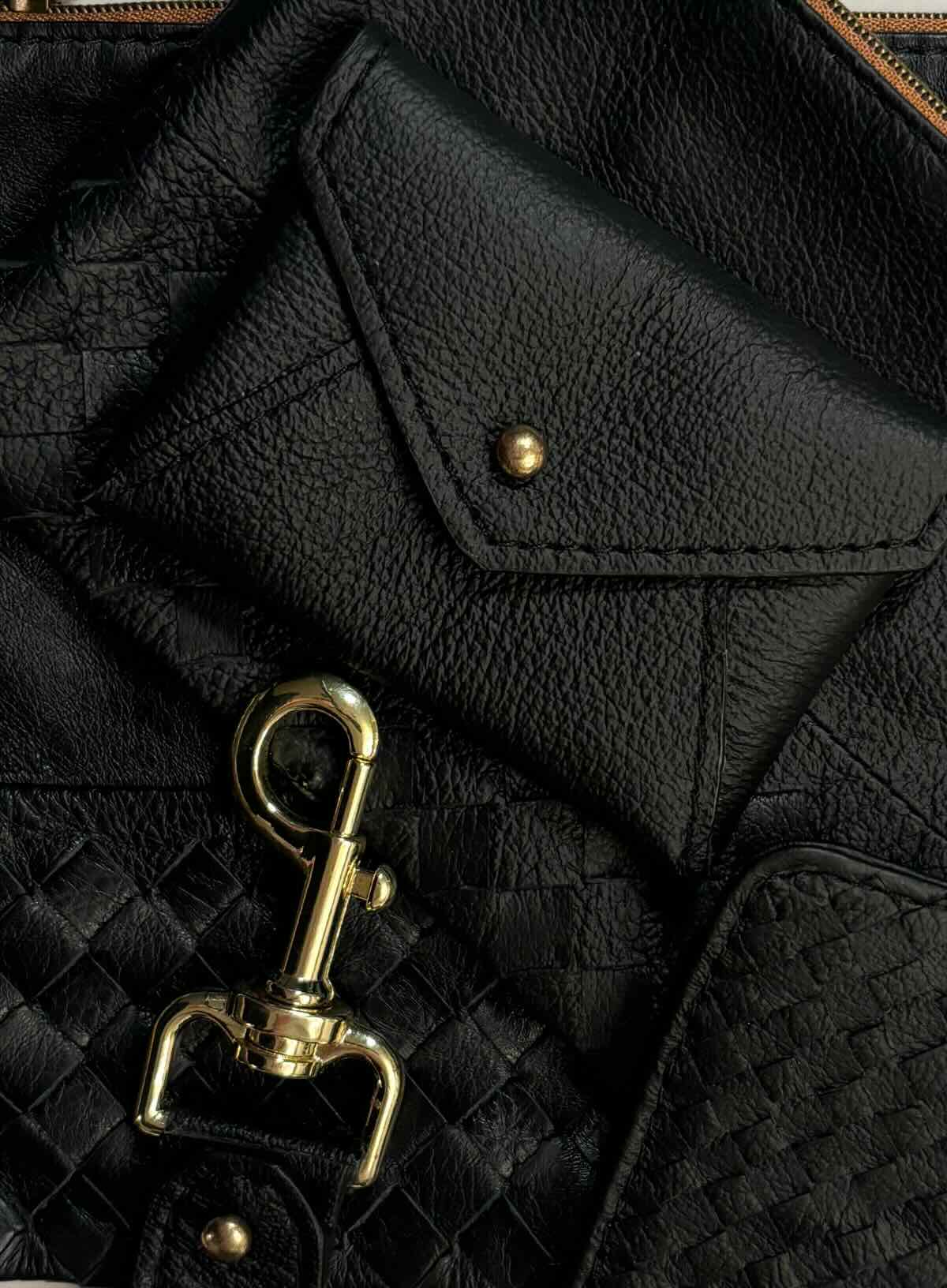 Close-up of black leather accessories with gold hardware