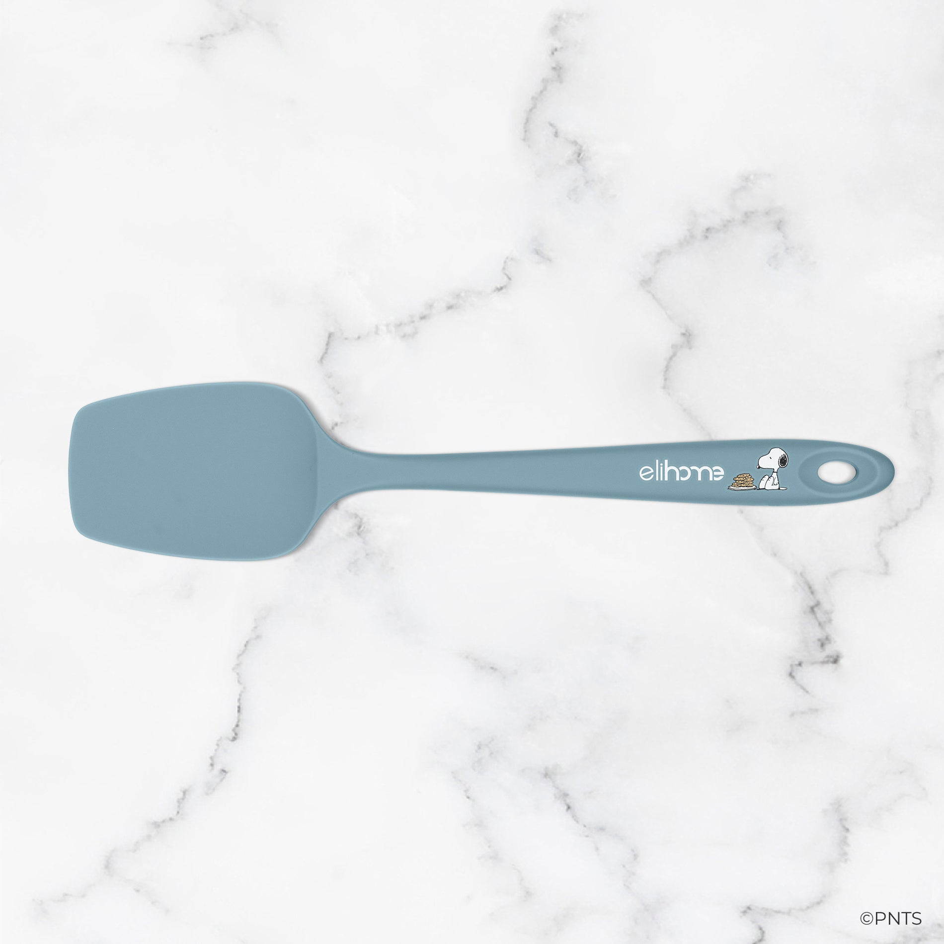 Blue spatula with a brand logo on a marble background