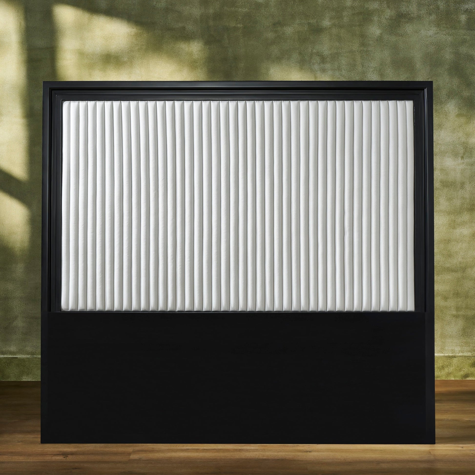 FN-5211-6080_1|Rectangular black framed headboard with a white vertically channel-quilted leather upholstered panel. Features a solid black base.