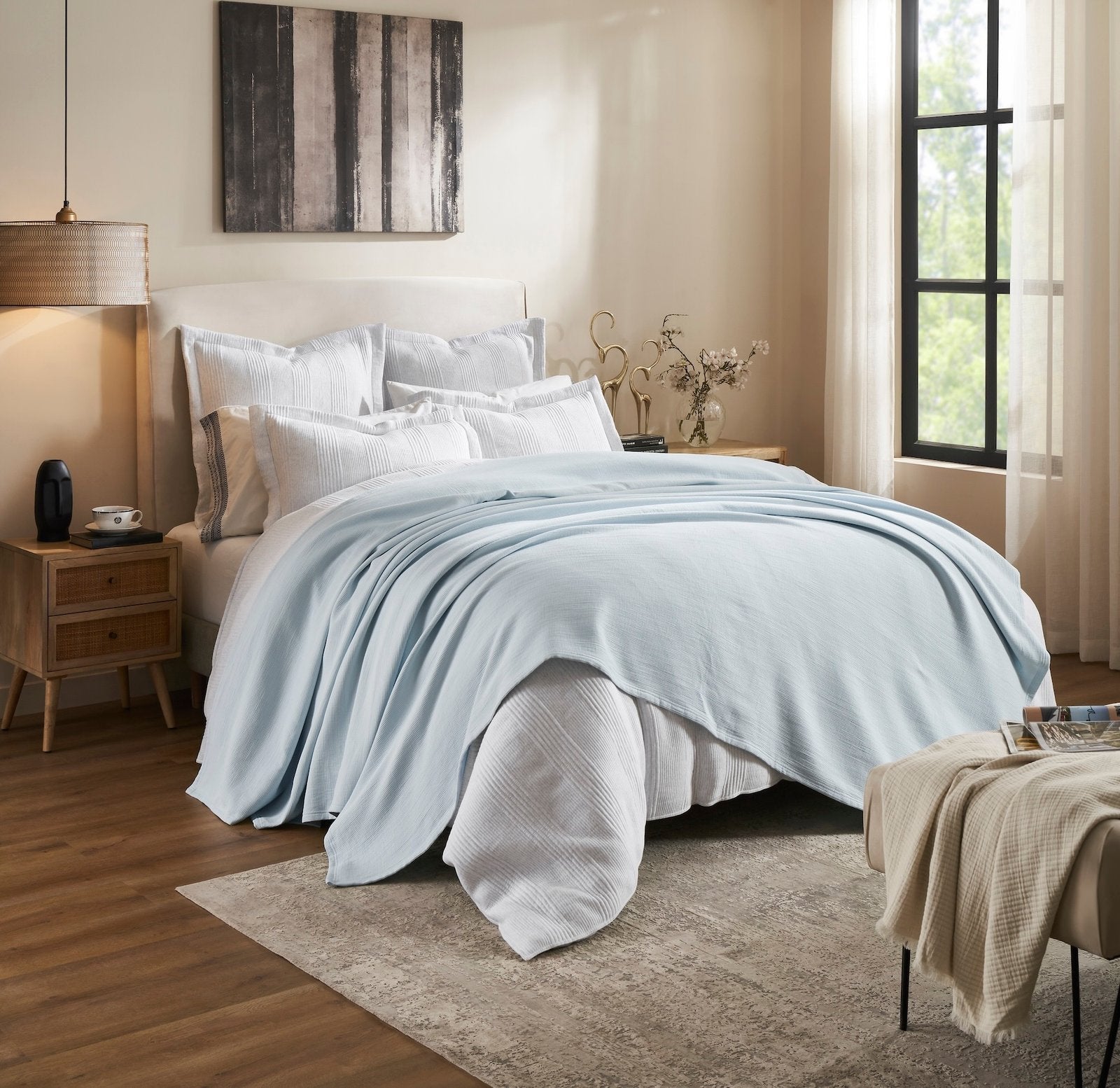 BL-859-9496_2|Light blue waffle weave blanket casually draped over a white bed in a contemporary bedroom. Adds comfort and style.