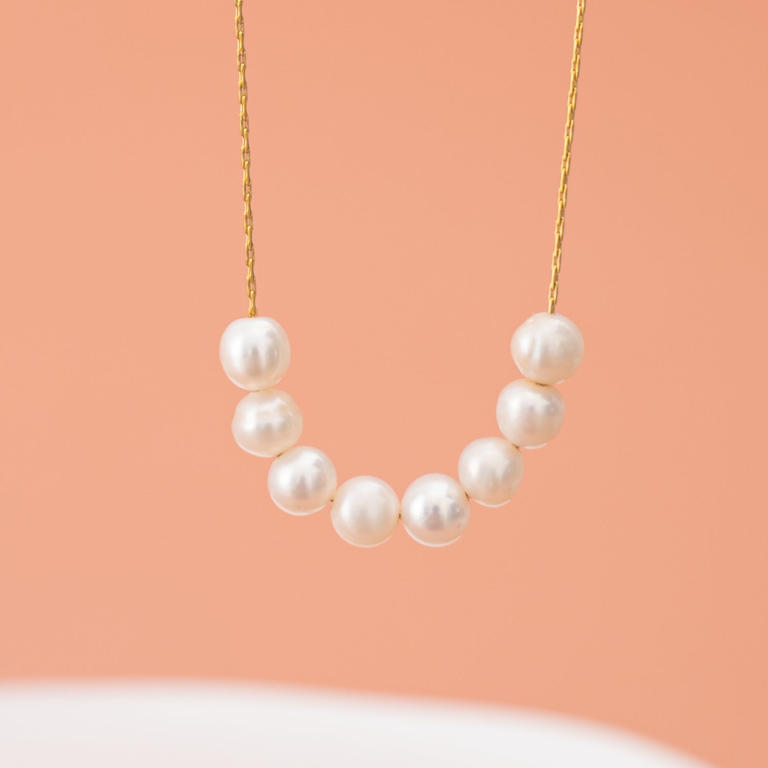 Pearl center gold necklace, simplistic beautiful necklace, best fait trade gifting companies, symbol for hope