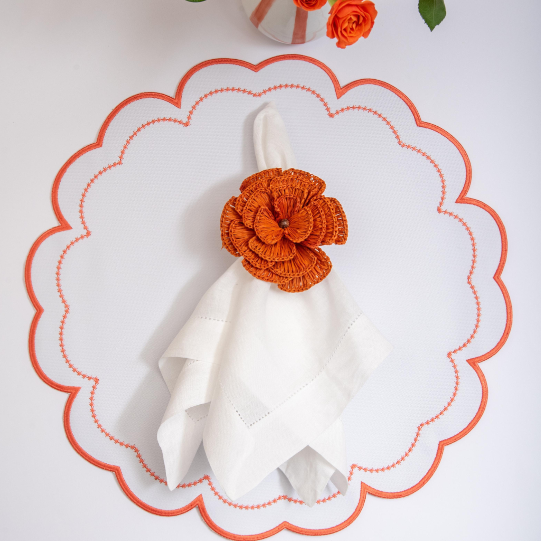 The orange Victoria impermeable placemat with Victorian-style border detail by Talah Home