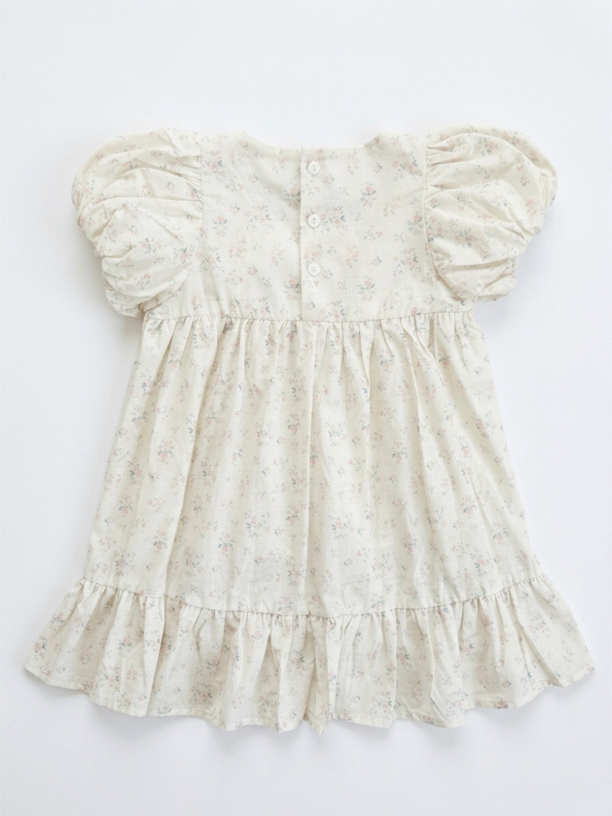 White floral dress with puff sleeves on a white background