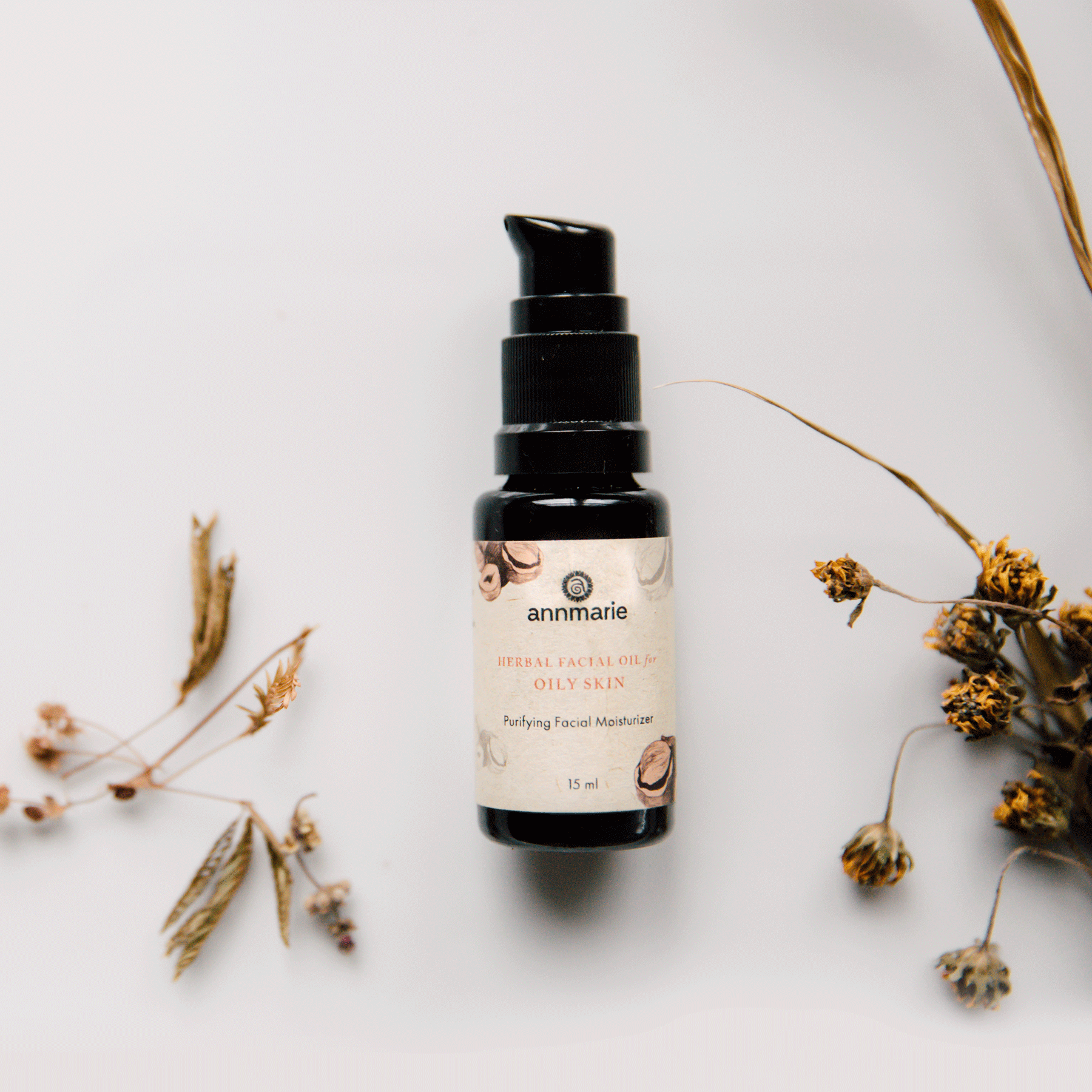 Herbal Facial Oil for oily skin with enhanced herb formula, purifying facial moisturizer bottle surrounded by dried botanicals.