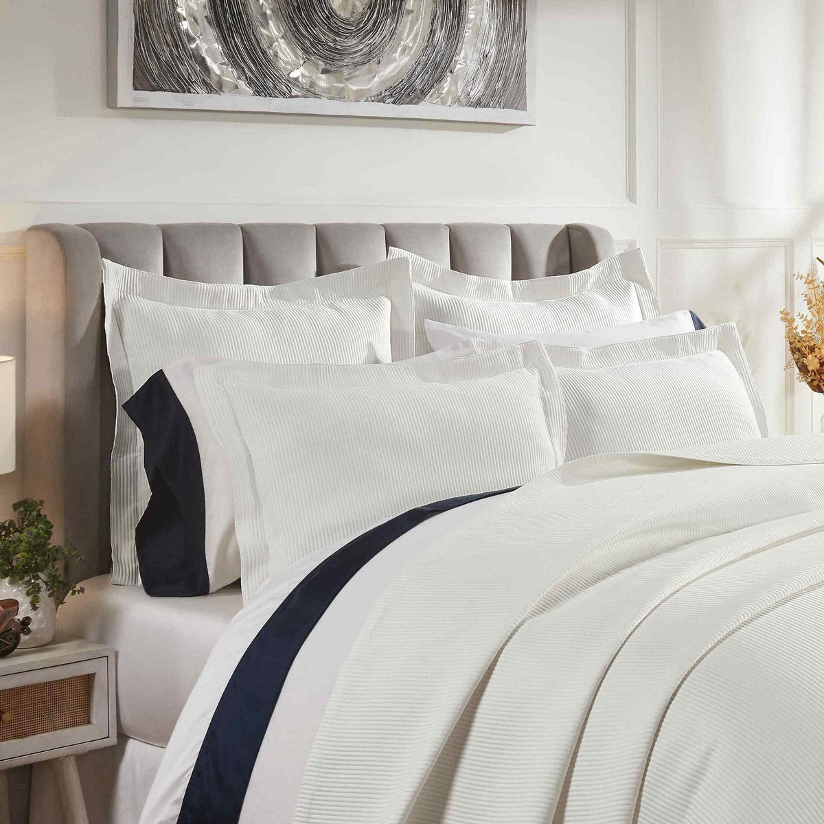 CL-192-11096_3|Detailed view of a crisp white striped coverlet and matching pillows, showcasing a luxurious and textured bedding ensemble.