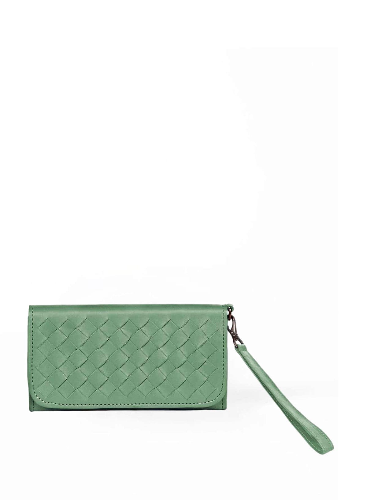 woven wristlets in different colors in front of flowers.